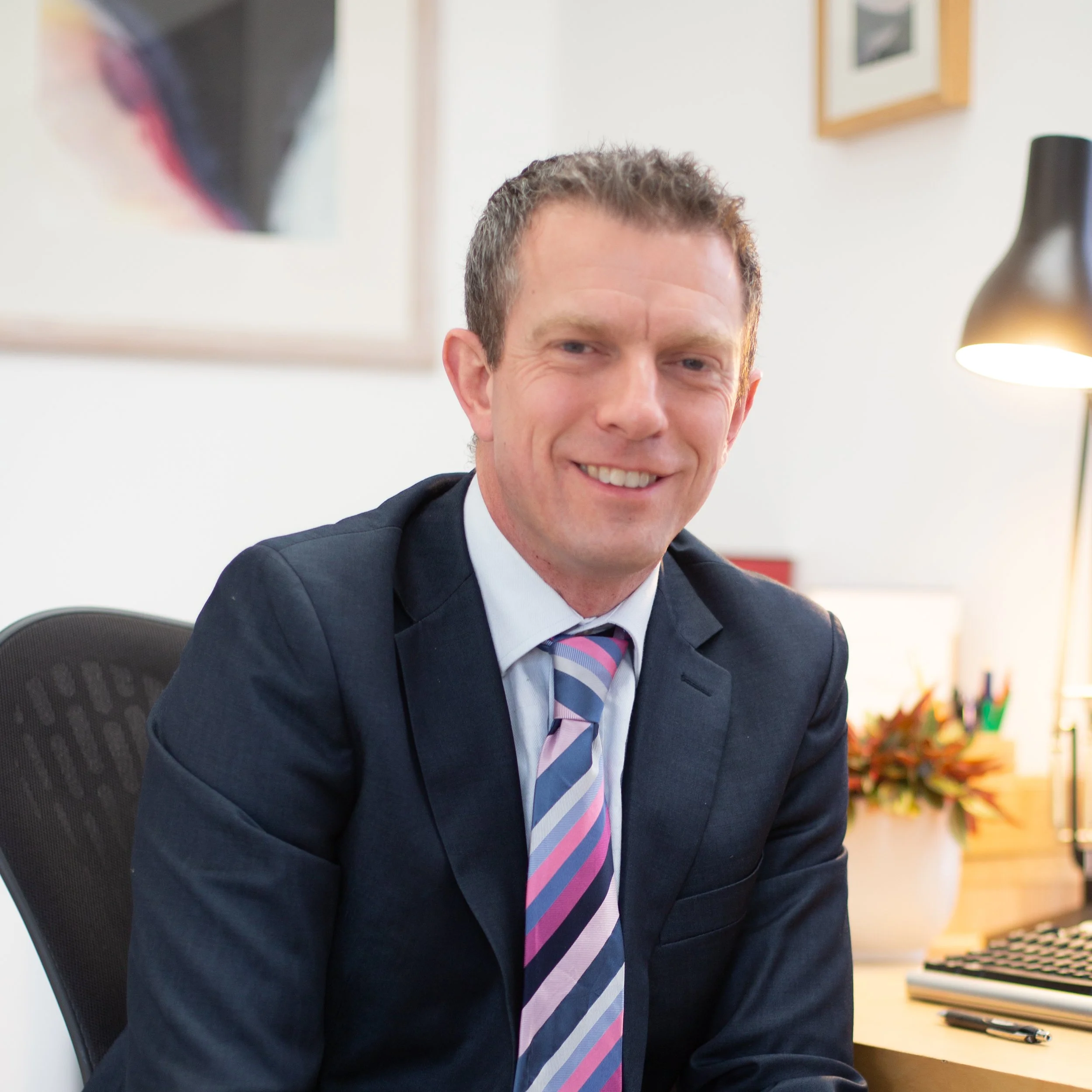 Dr Mike Marriott, Clinical Psychologist (Sat reading in an office)