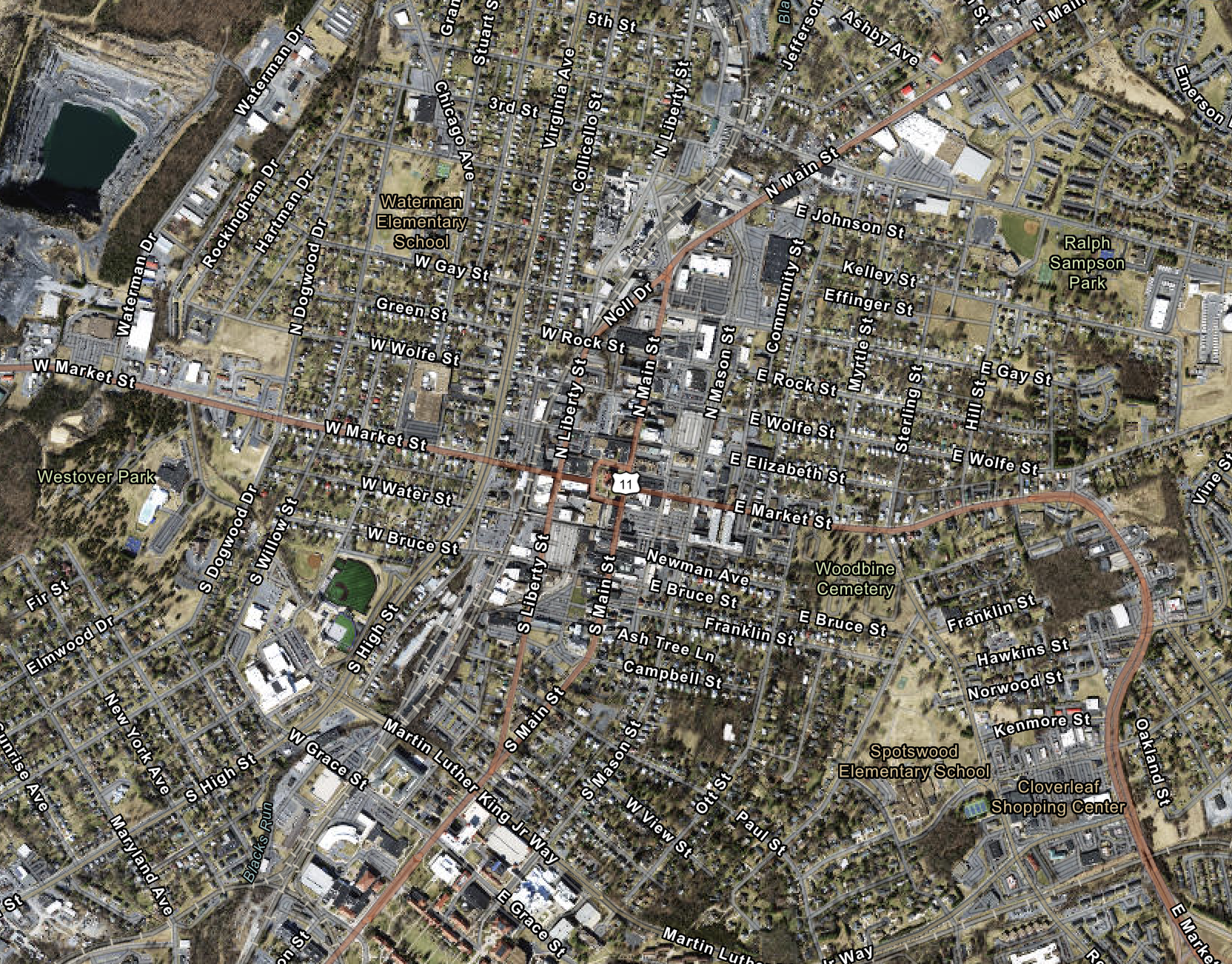 An aerial view of a small city with streets, parks, and buildings. Notable landmarks include Waterman Elementary School, Westover Park, Ralph Sampson Park, Woodbine Cemetery, and Cloverleaf Shopping Center. Major roads such as W Market St, N Main St, and E Market St are visible.