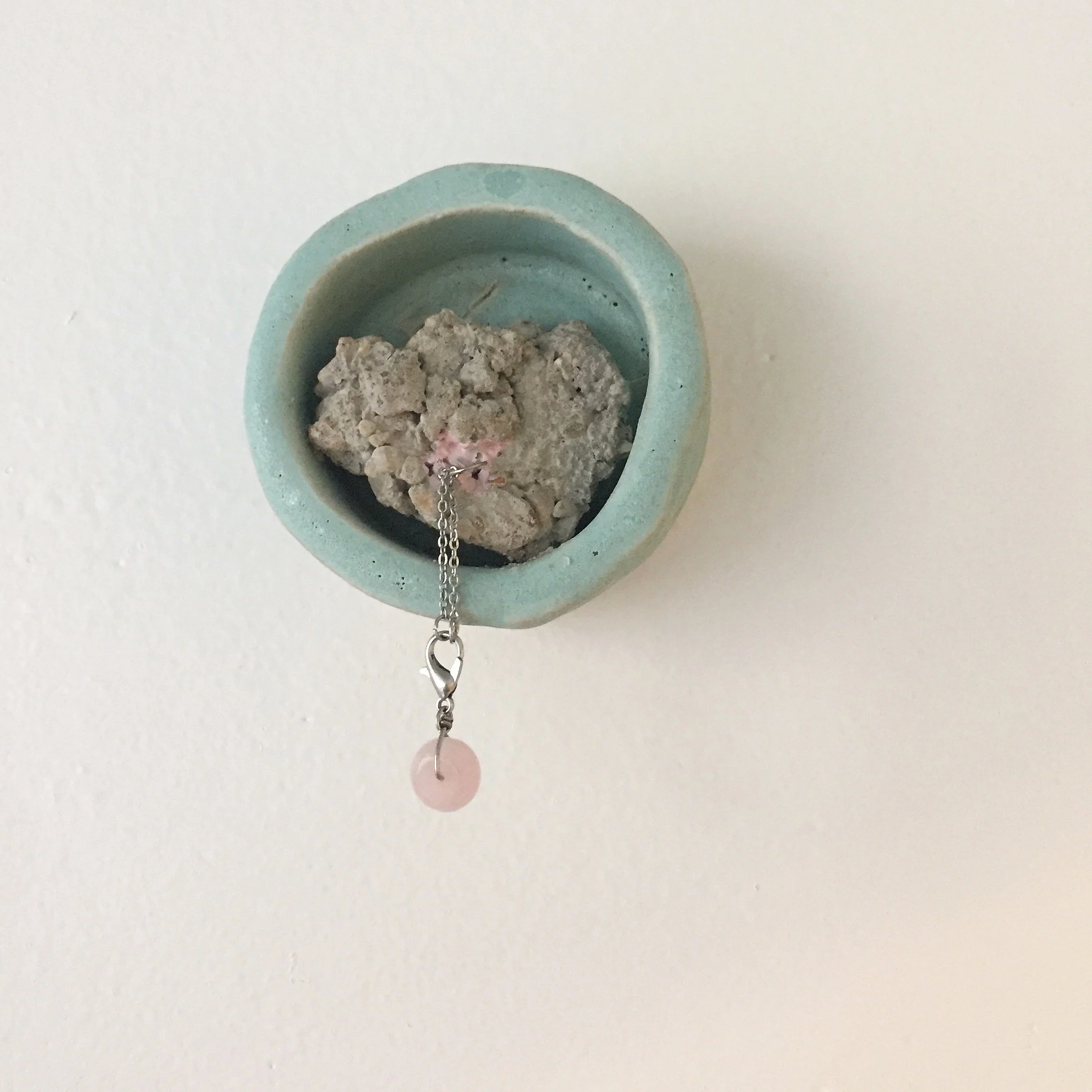 "Untitled" (Adornment Study ii)
/
concrete shard, ceramic structure, lobster clasp, chain, soft pink nail polish, wire, rose quartz bead
/
(2019)