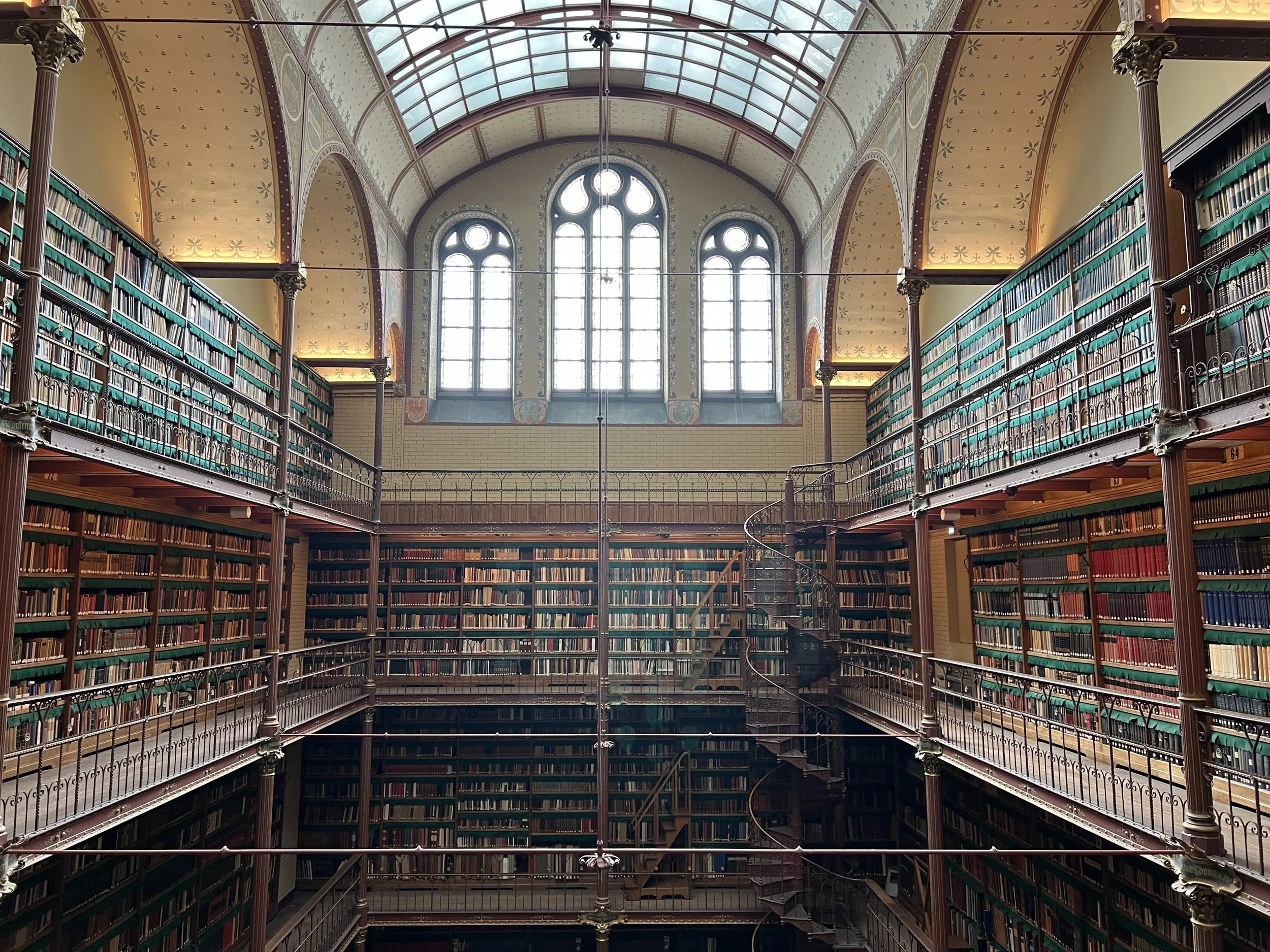 Historic academic library interior with bookshelves and reading galleries.