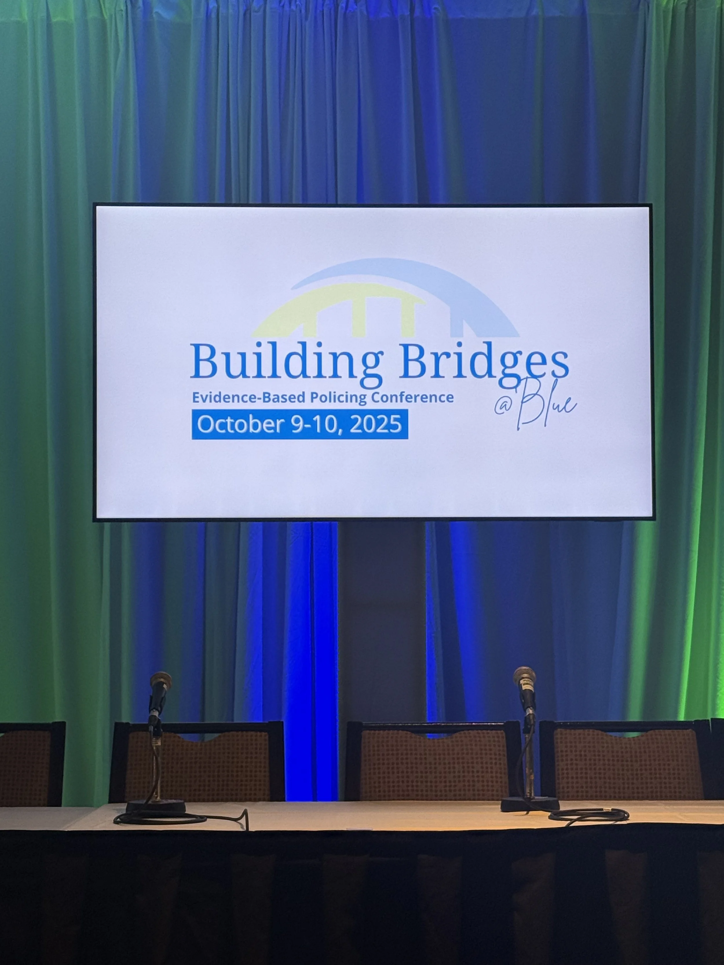 Conference stage and presentation screen at the Building Bridges evidence-based policing conference.