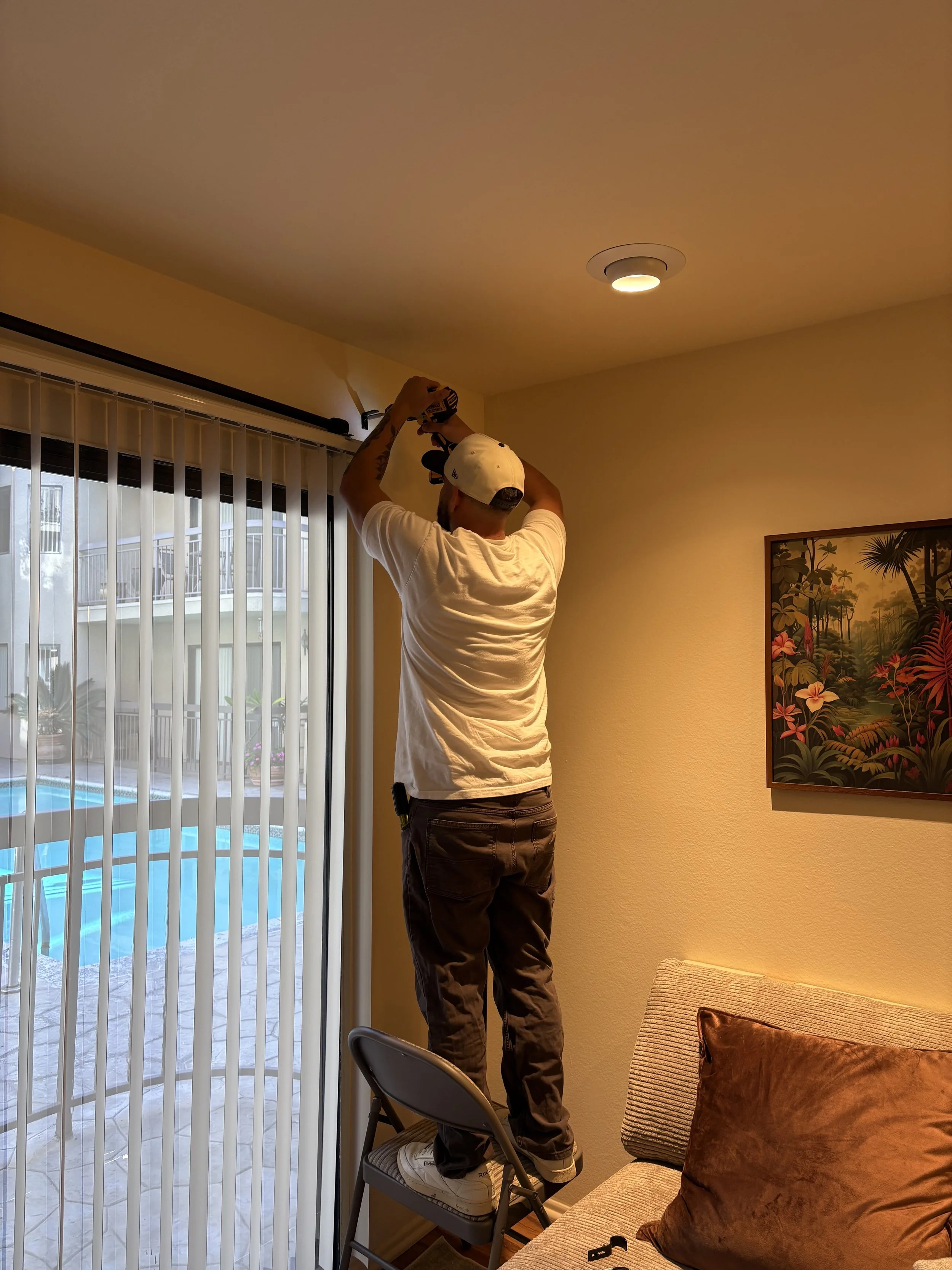 Installing a curtain rod using a drill for secure wall mounting in Mission Viejo, CA