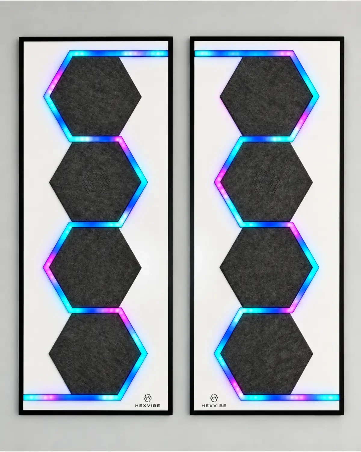 Two illuminated HexVIBE FLOW Slate sound-reactive LED acoustic wall panels arranged as a mirrored pair with blue, cyan and magenta lighting