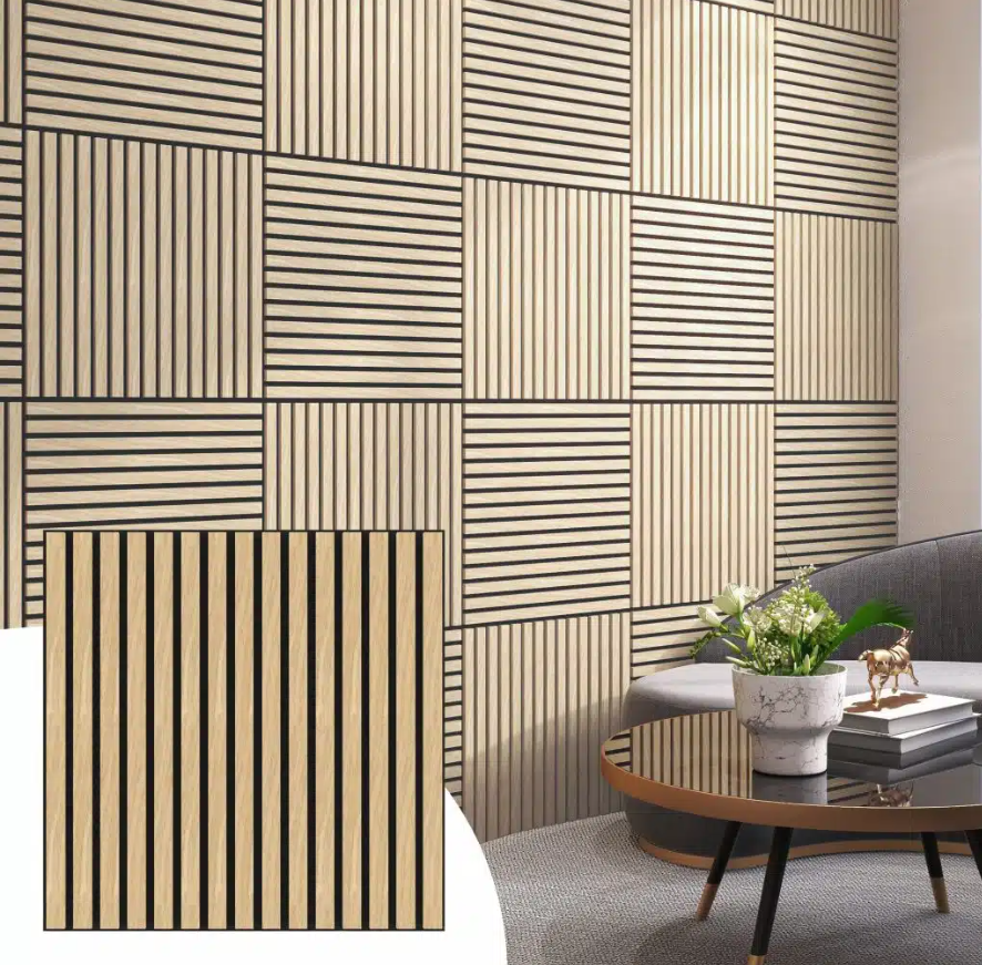 Interior room with a wooden slat wall, a gray sofa, a round coffee table with a plant and decorative items.