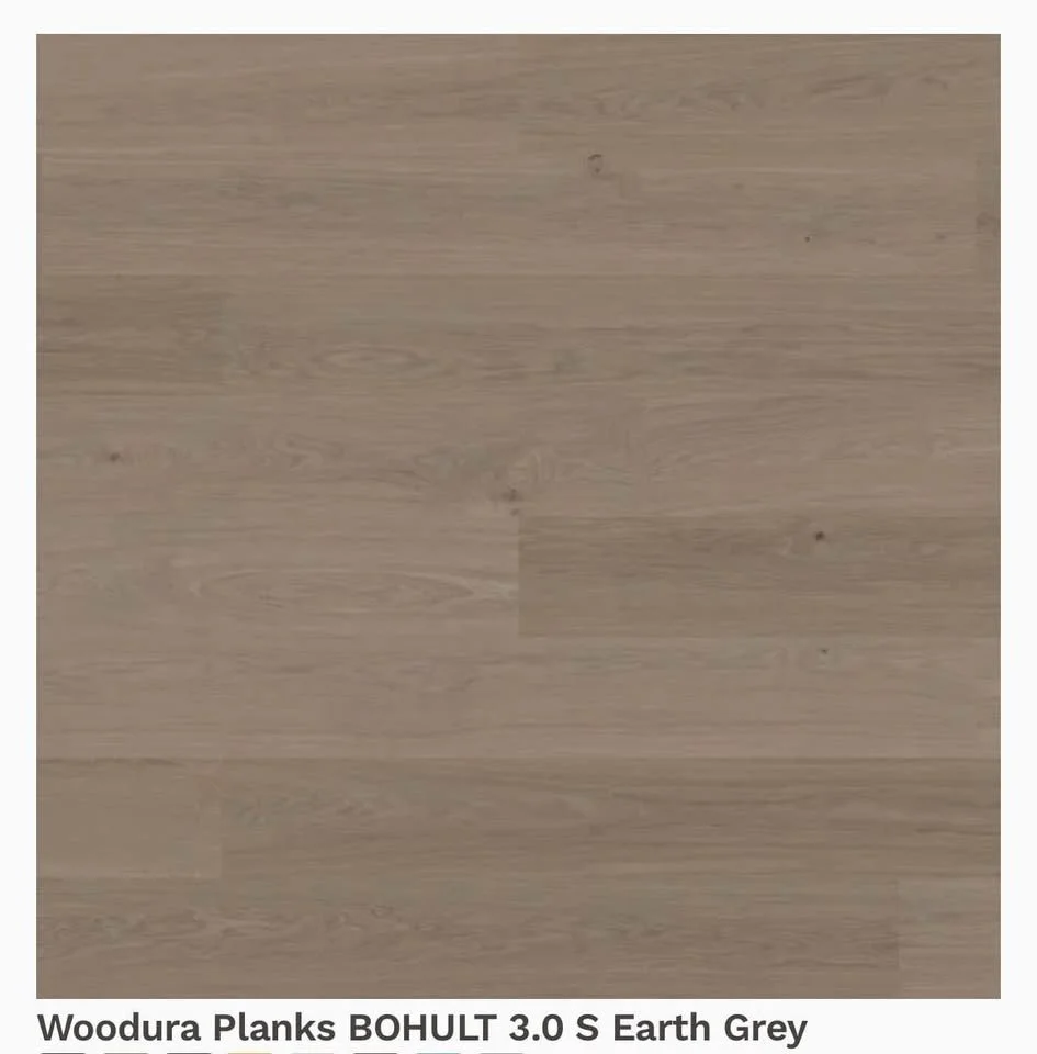 A light brown wooden floor with a subtle wood grain pattern.
