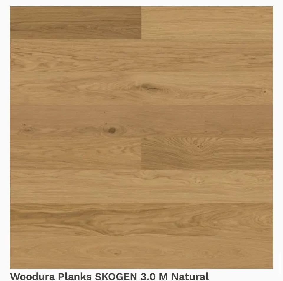 Close-up of a wooden surface, showing natural wood grain patterns, knots, and a light oak color.