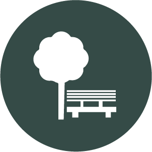Icon of a tree and a bench in a park setting
