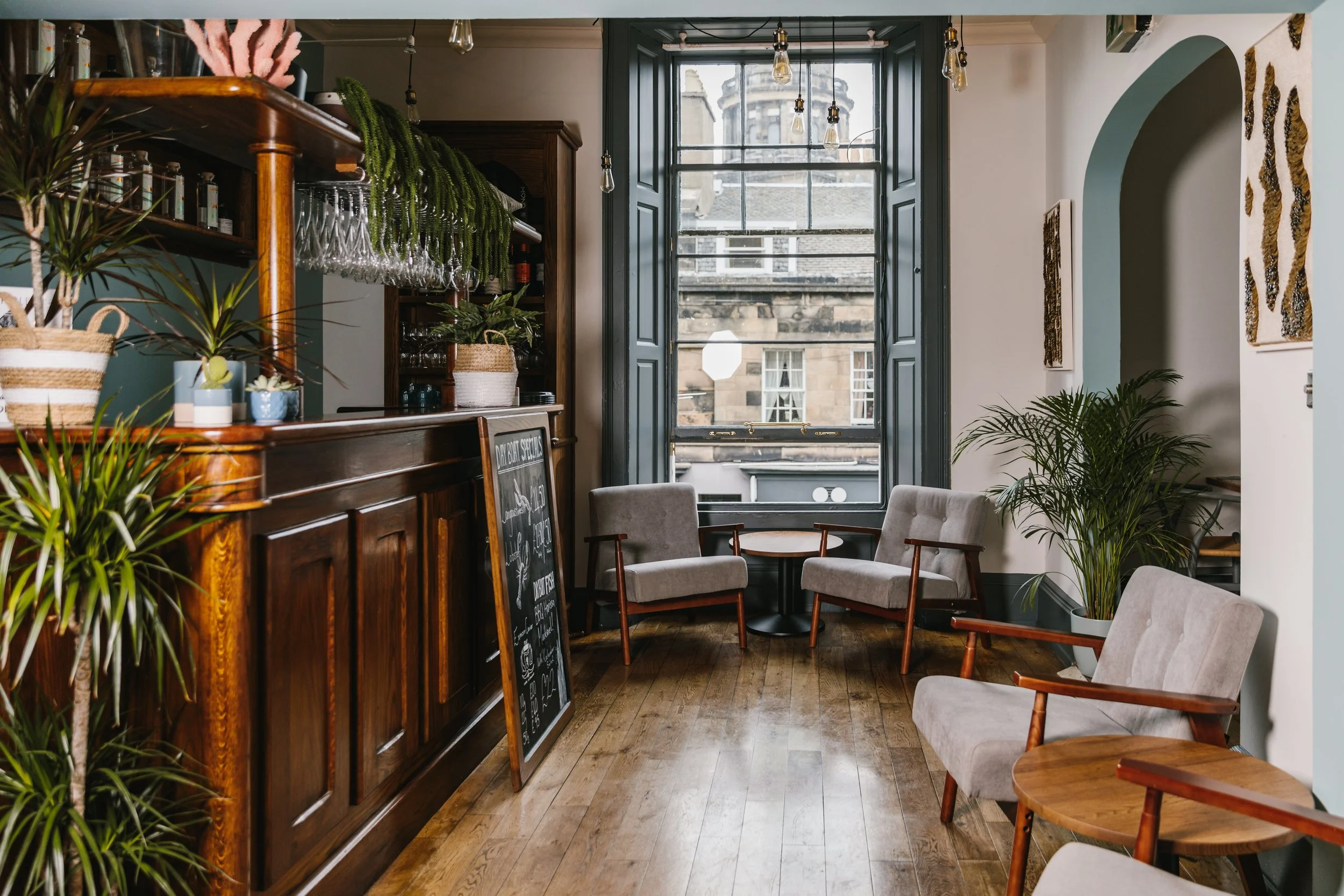 reception area of a restaurant with a bar and seating
