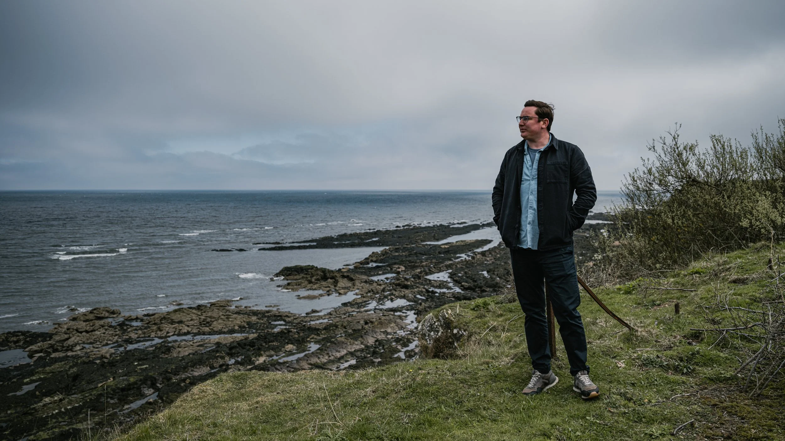 Chef Dean Banks standing at a coastal area