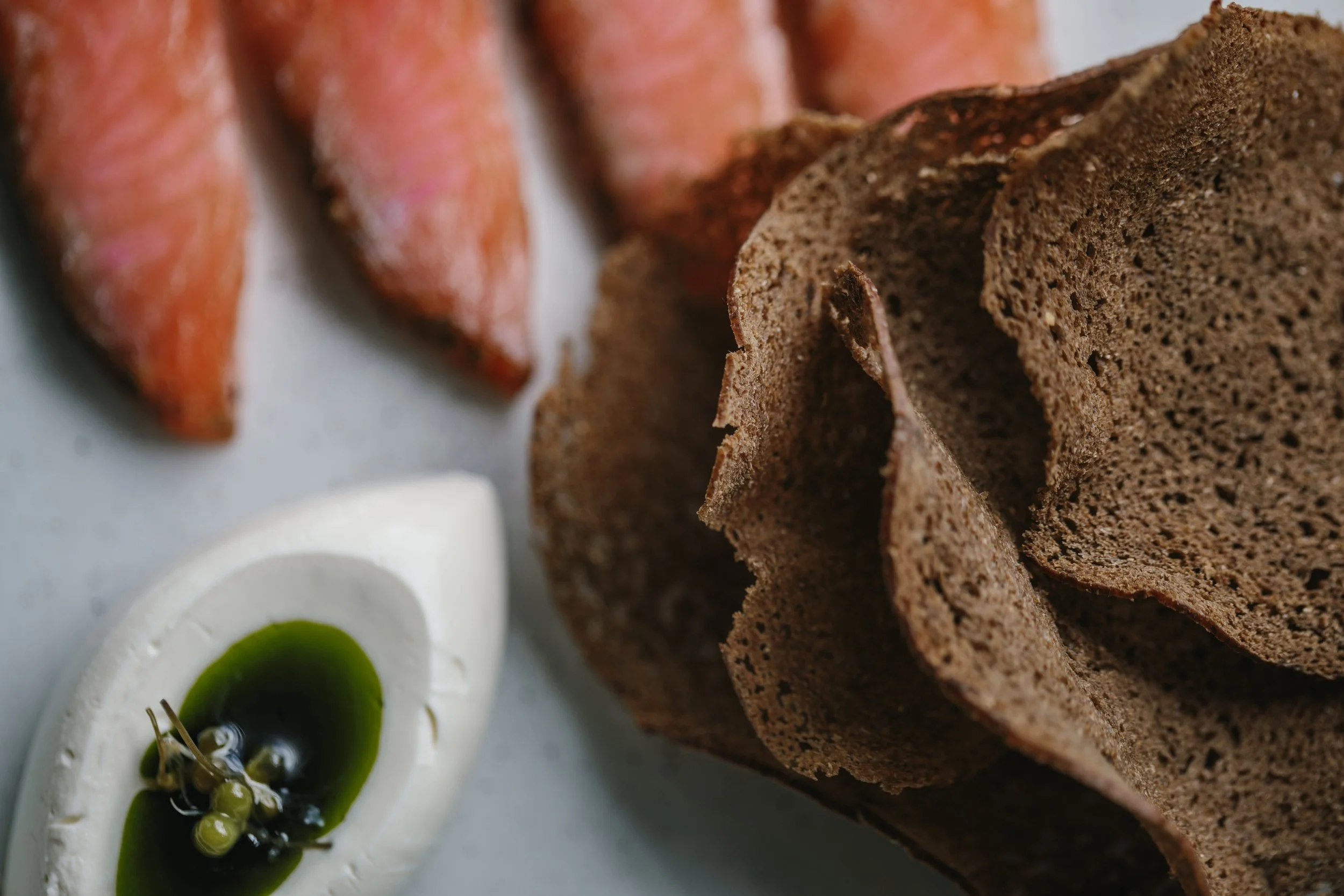 peppered trout, katy rogers creme fraiche, herb oil, rye crackers
