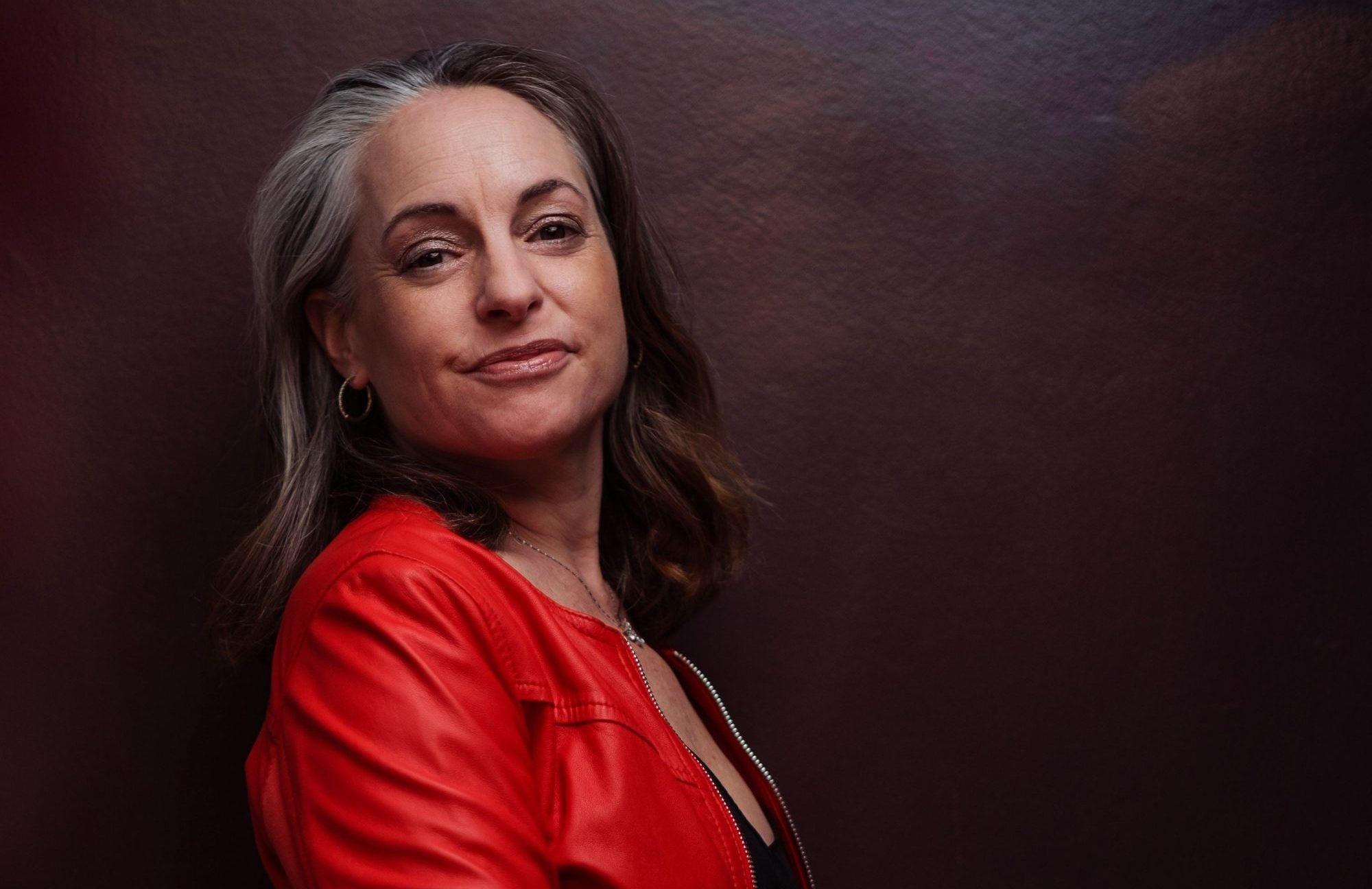 Headshot of smiling male tutor with medium-length black hair wearing a lanyard.