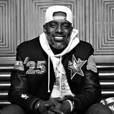 Headshot of smiling female tutor with short blonde hair wearing a lanyard.