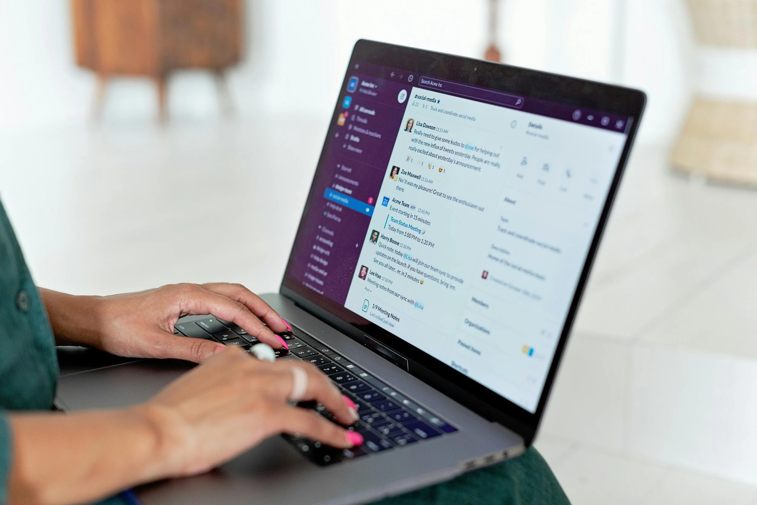 Close-up of a person typing on a laptop.