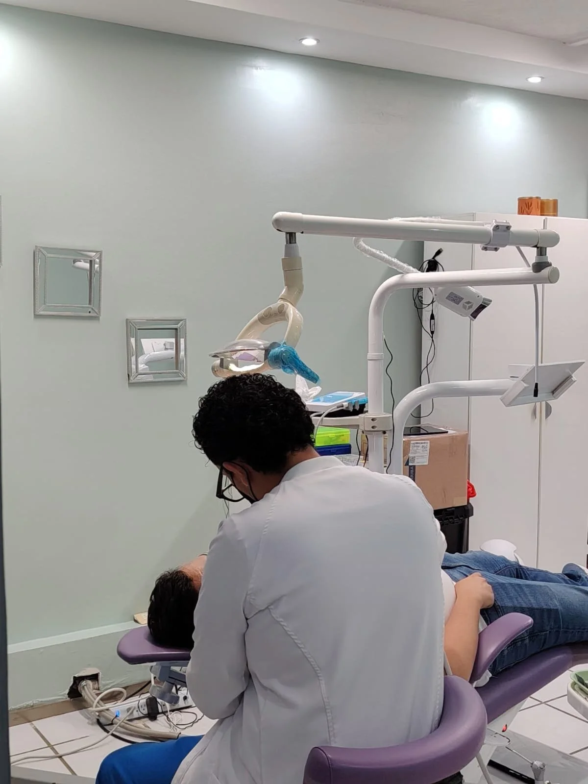 A dental procedure being performed at Dental Playa on a patient lying on a treatment chair.
