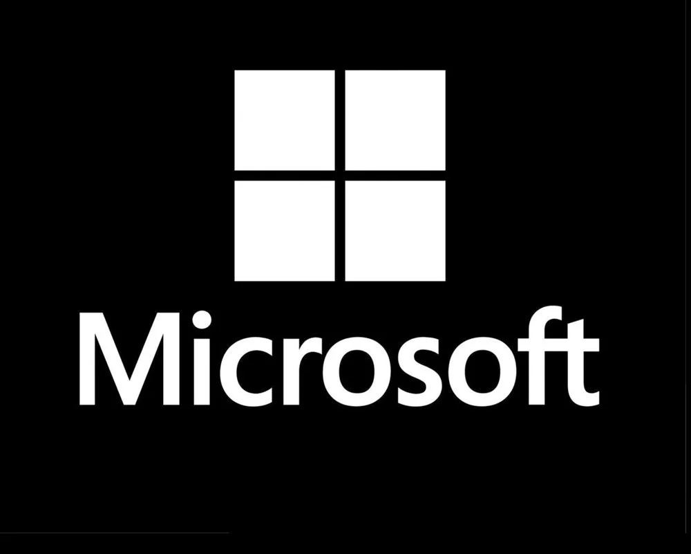 Microsoft logo with four squares above the word 'Microsoft' on a black background.