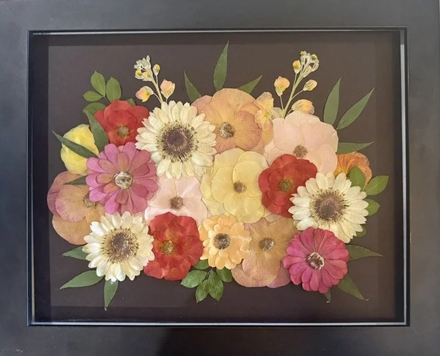 Colorful pressed flower arrangement in a black frame on black mat background | Floral Preservation | Austin, TX  