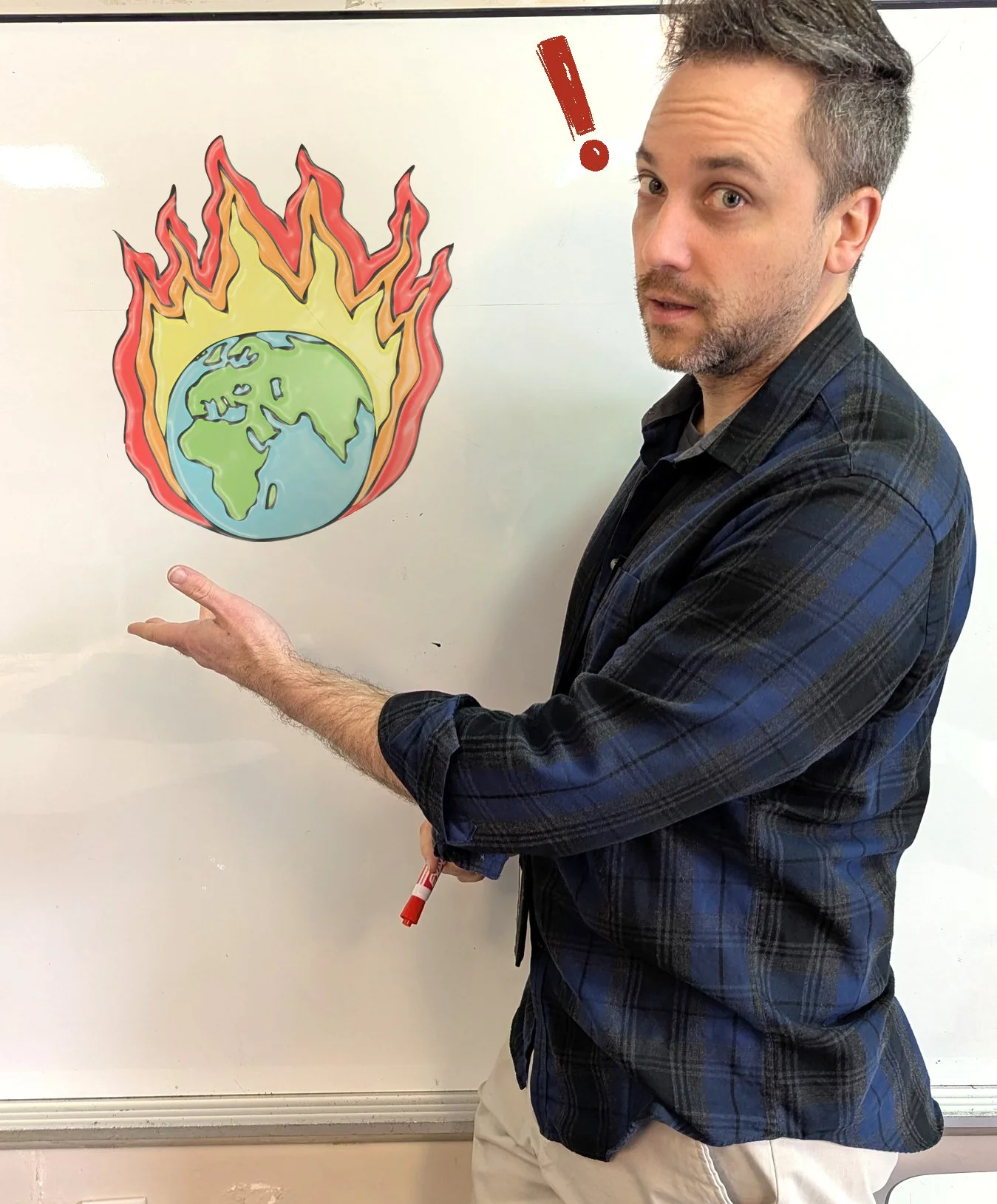 A man pointing at a drawing of Earth on a whiteboard, with flames surrounding it and an exclamation mark nearby.