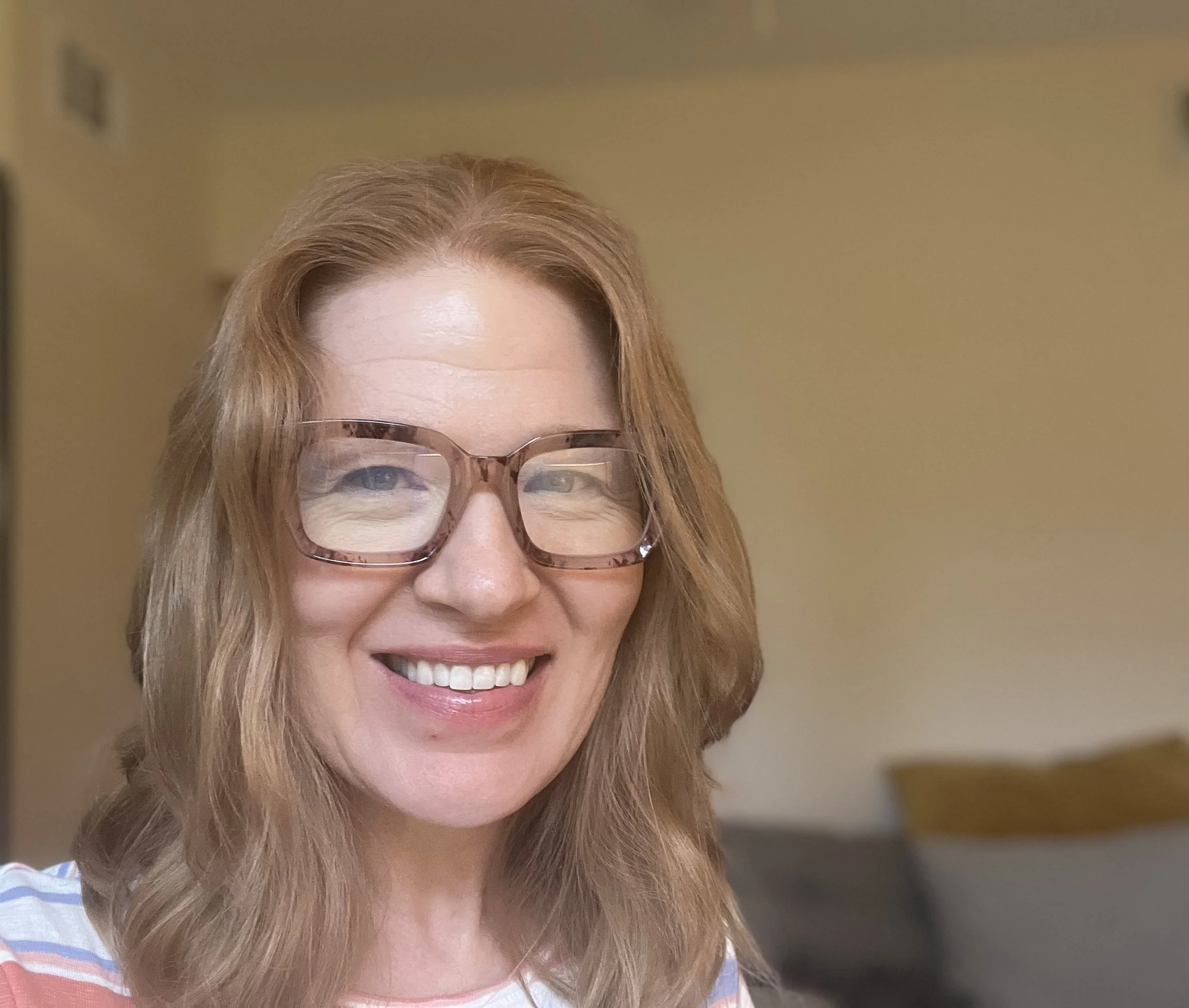 Kristen Johnson, a therapist who has glasses and shoulder length hair.