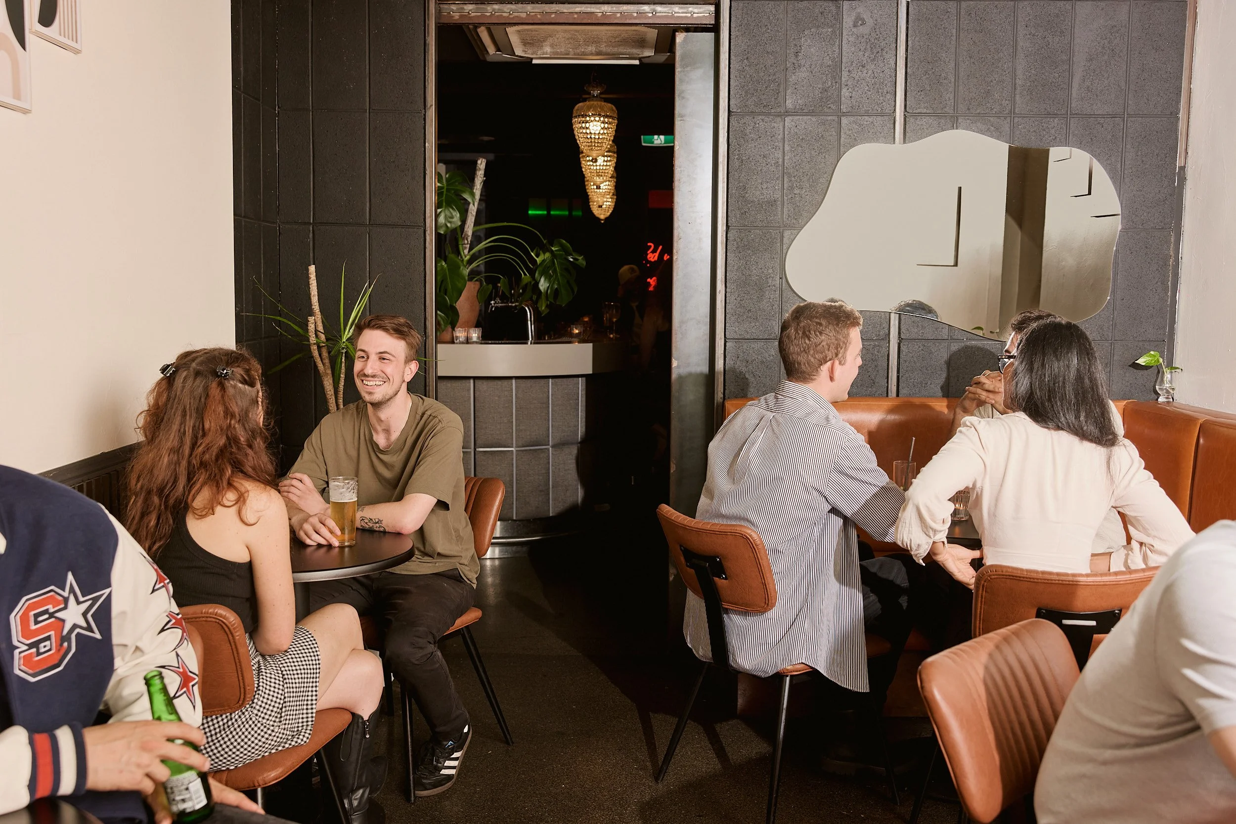 Guests enjoying drinks at Little Red’s hidden cocktail bar in Melbourne CBD.