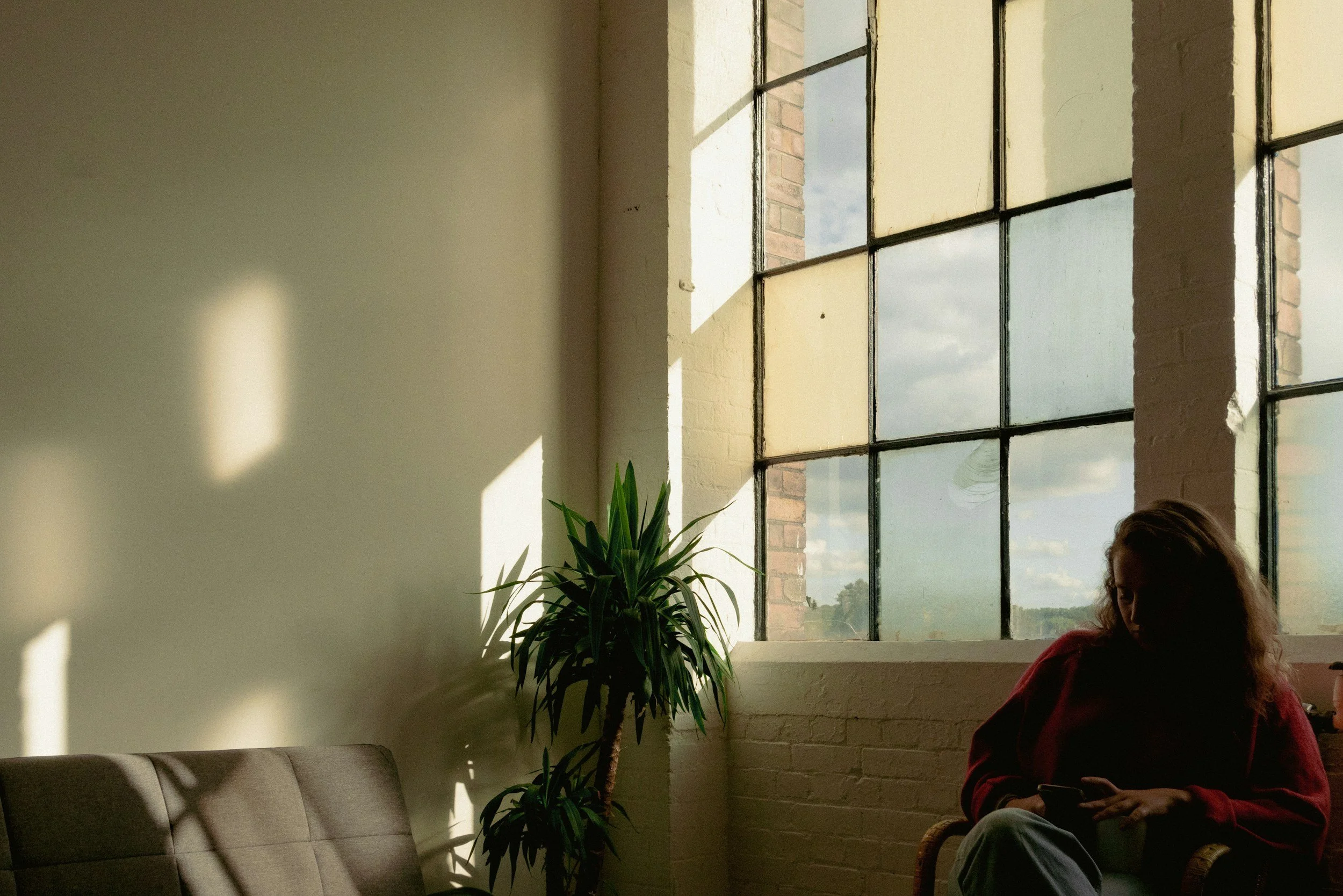 woman sitting therapy office natural light calm