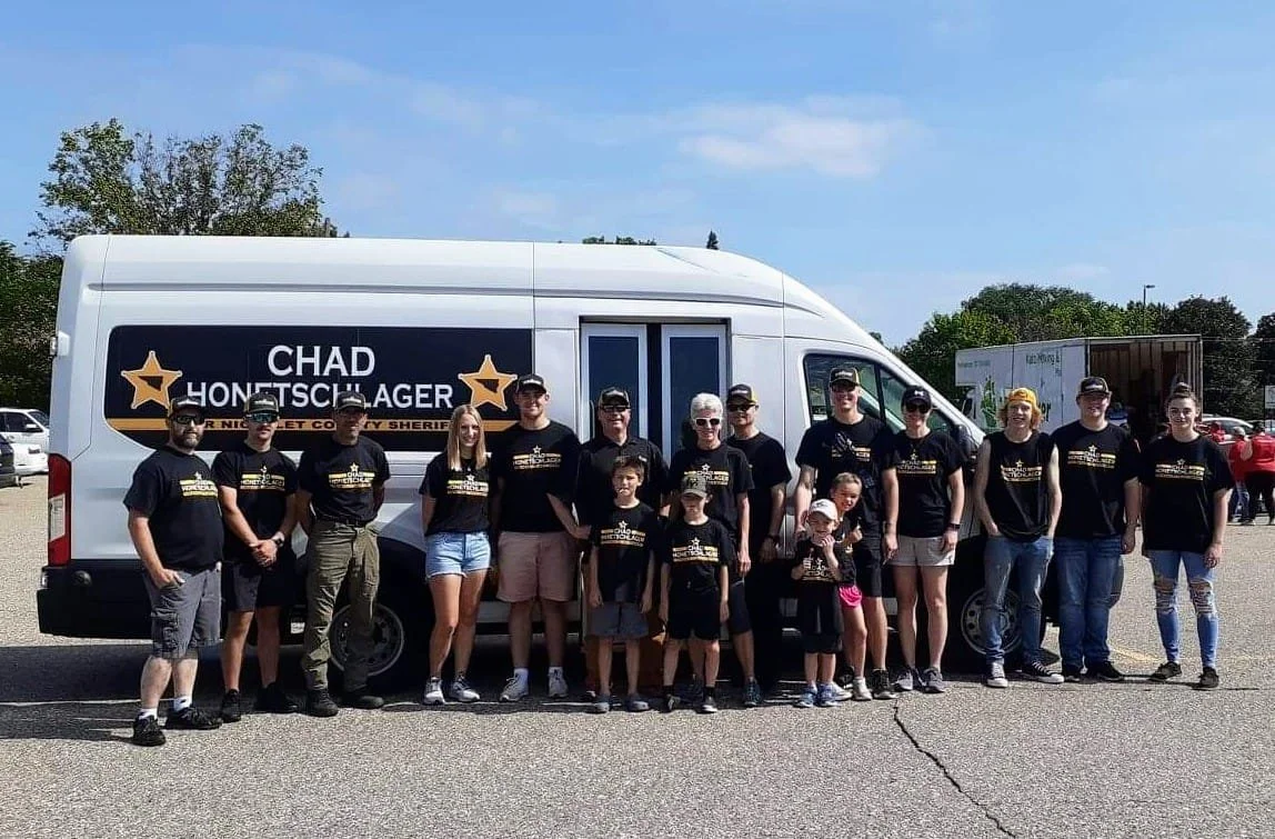 Volunteers at an event with the Honetschlager for Nicollet County Sheriff bus
