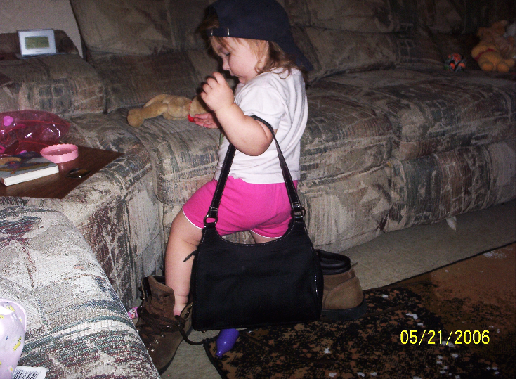 Sam testing out the “grown-up life” — purse, boots, and all