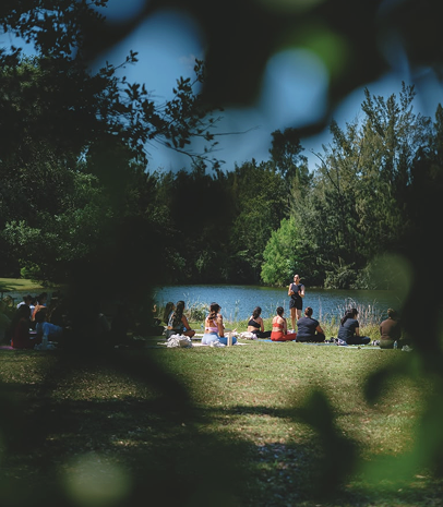 Women gathered outdoors by the water during a Selah breathwork retreat.