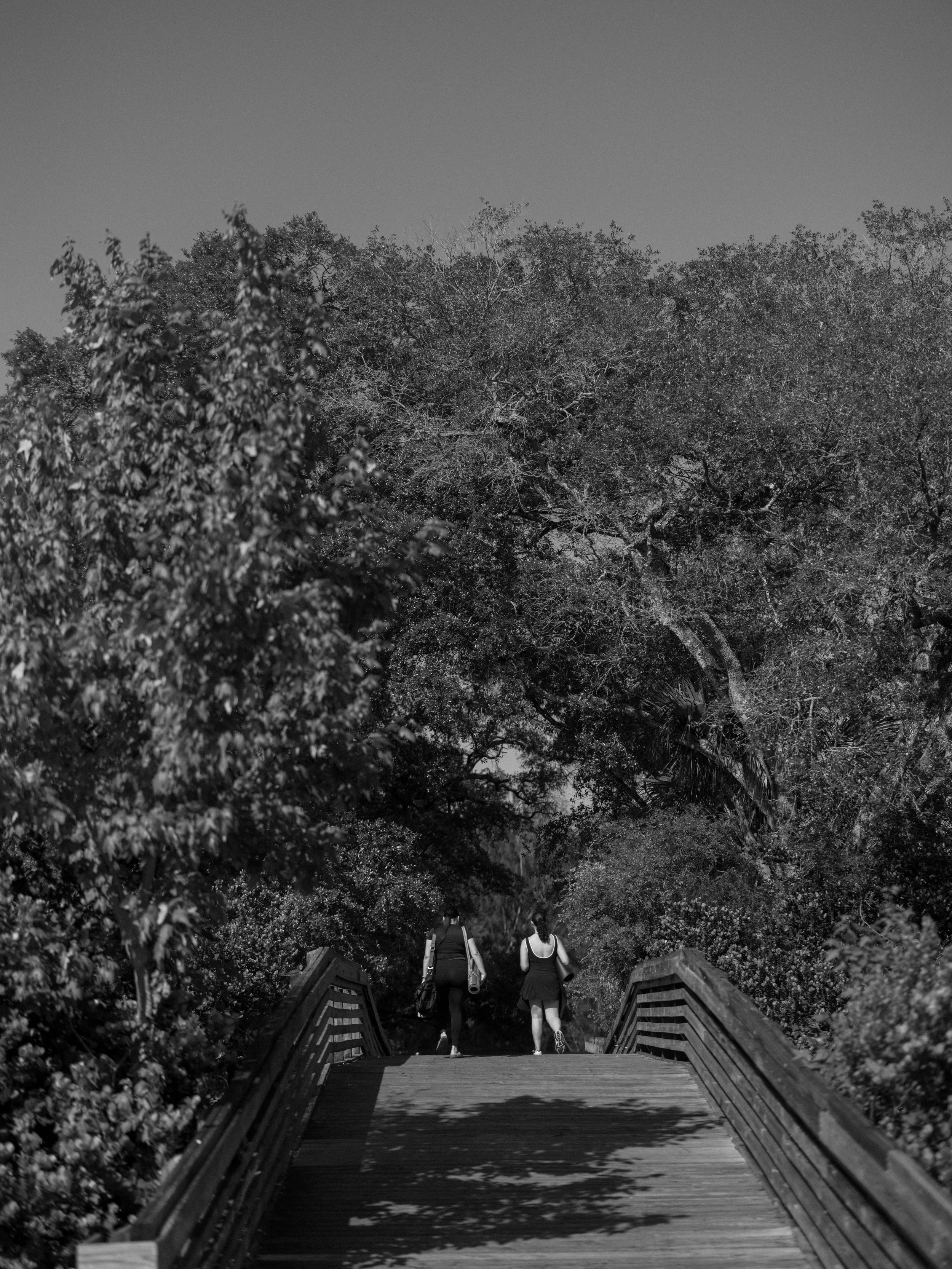 Two women walking outdoors on a bridge for Selah’s intentional living about page.