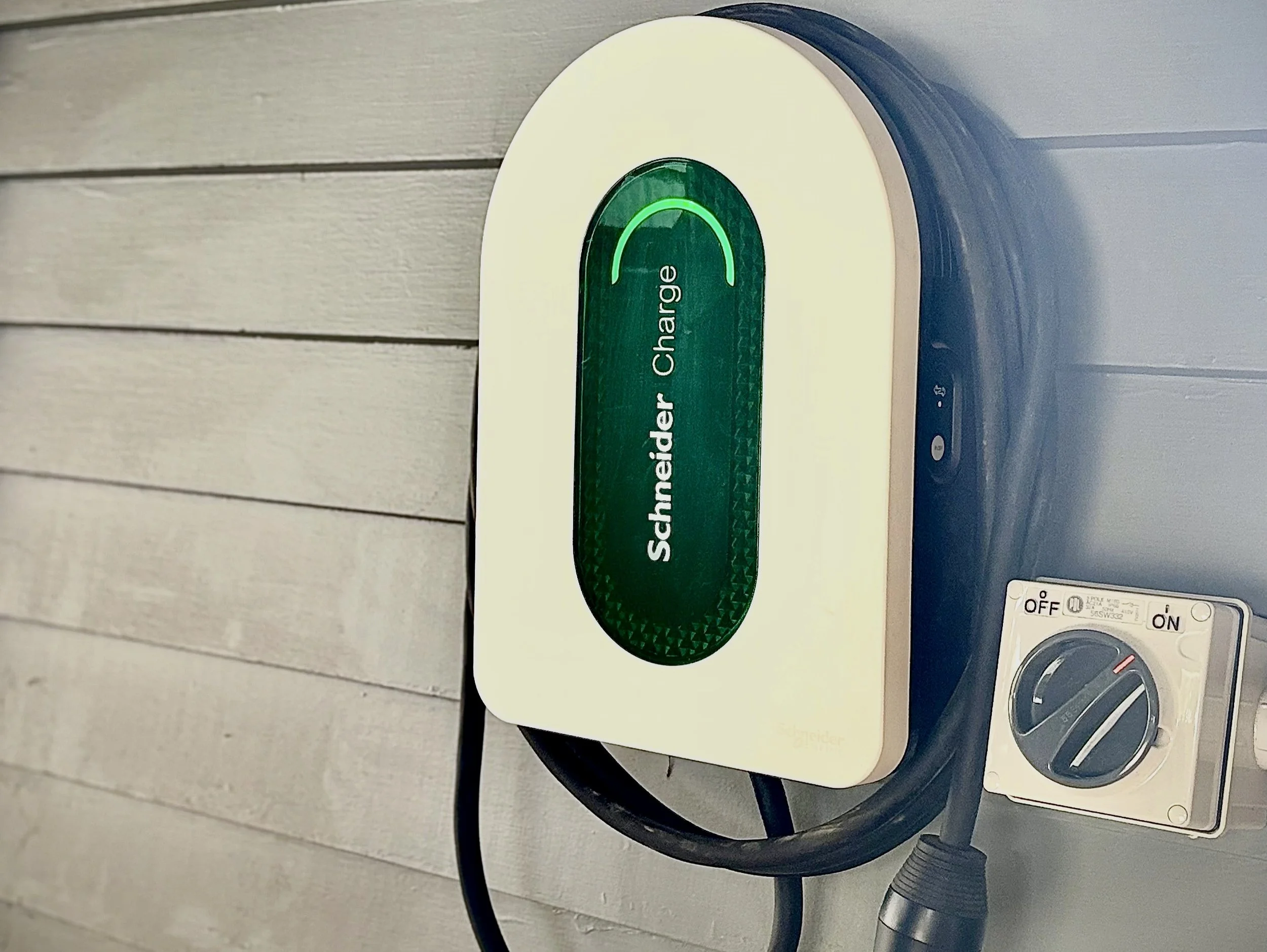 Close-up of a EV Charger attached to weatherboards