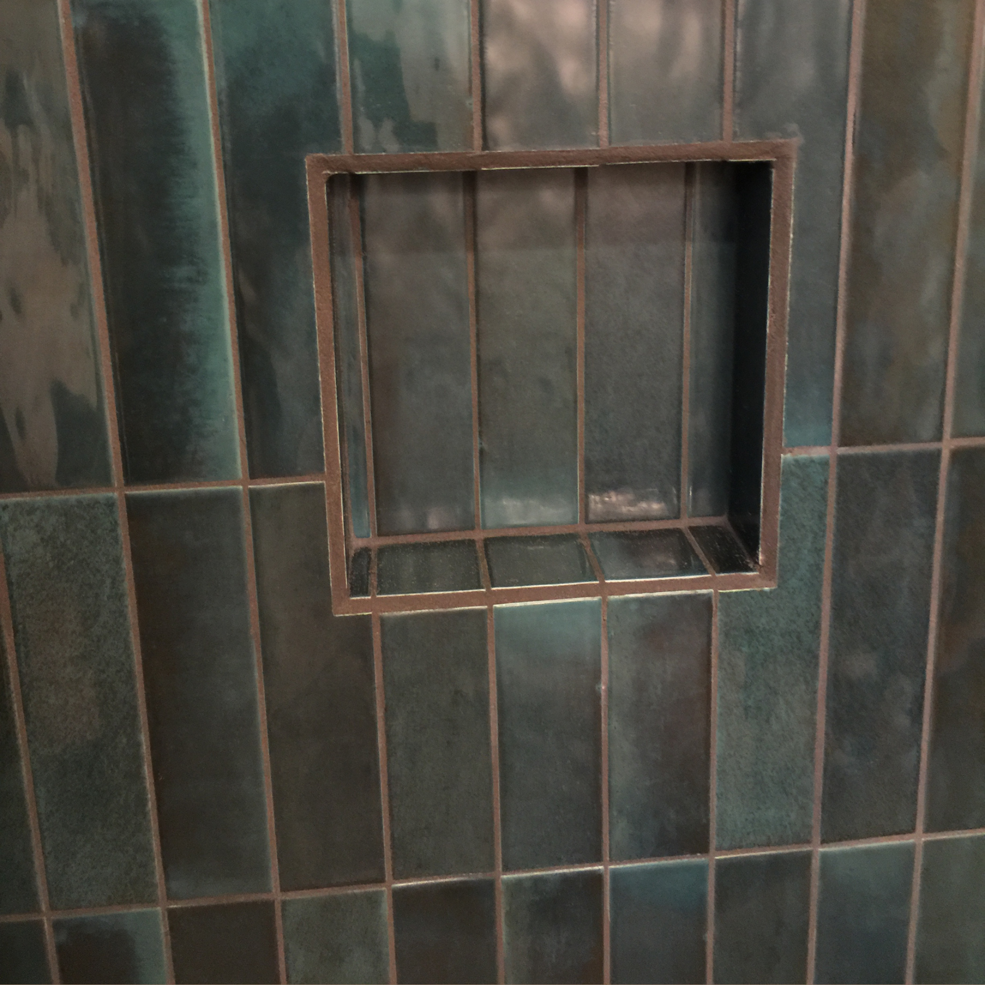 Teal tile shower niche