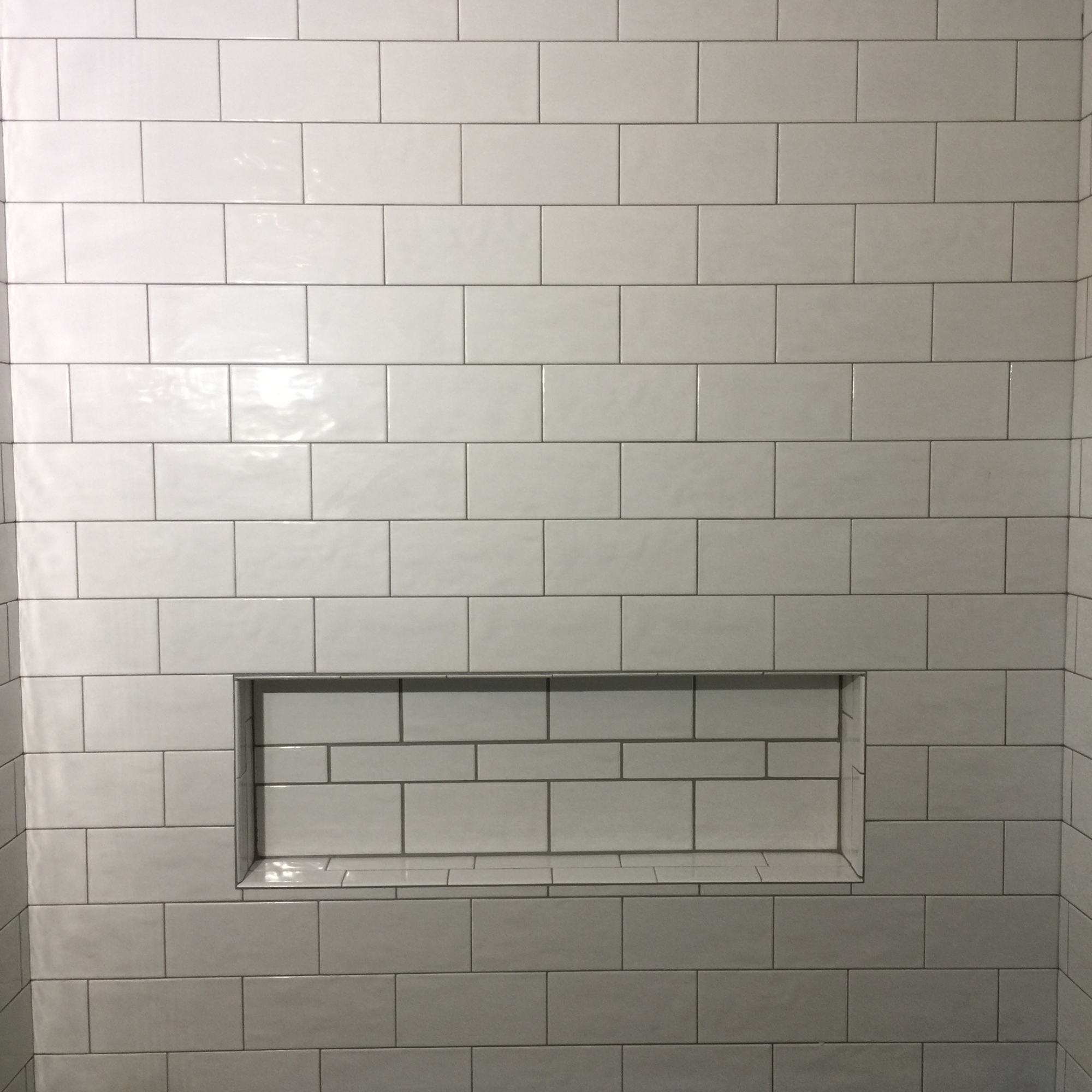 White tile shower and tub niche