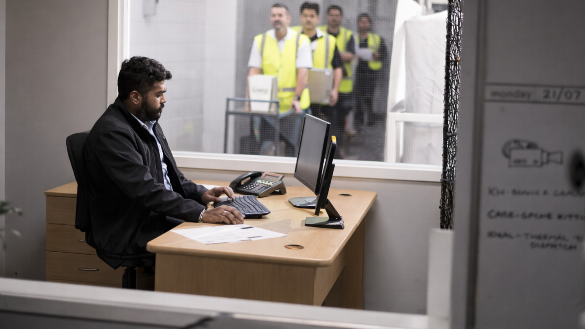 Malcove nz, our team and what we do, team working at a desk in an office, with a window behind him