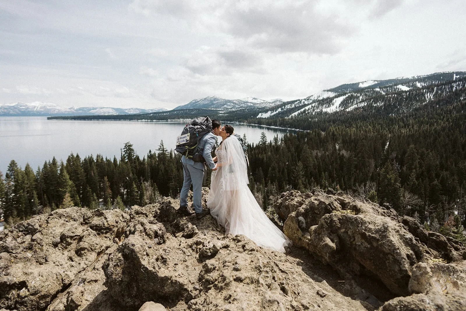 A bride and groom kissing on Eagle Rock