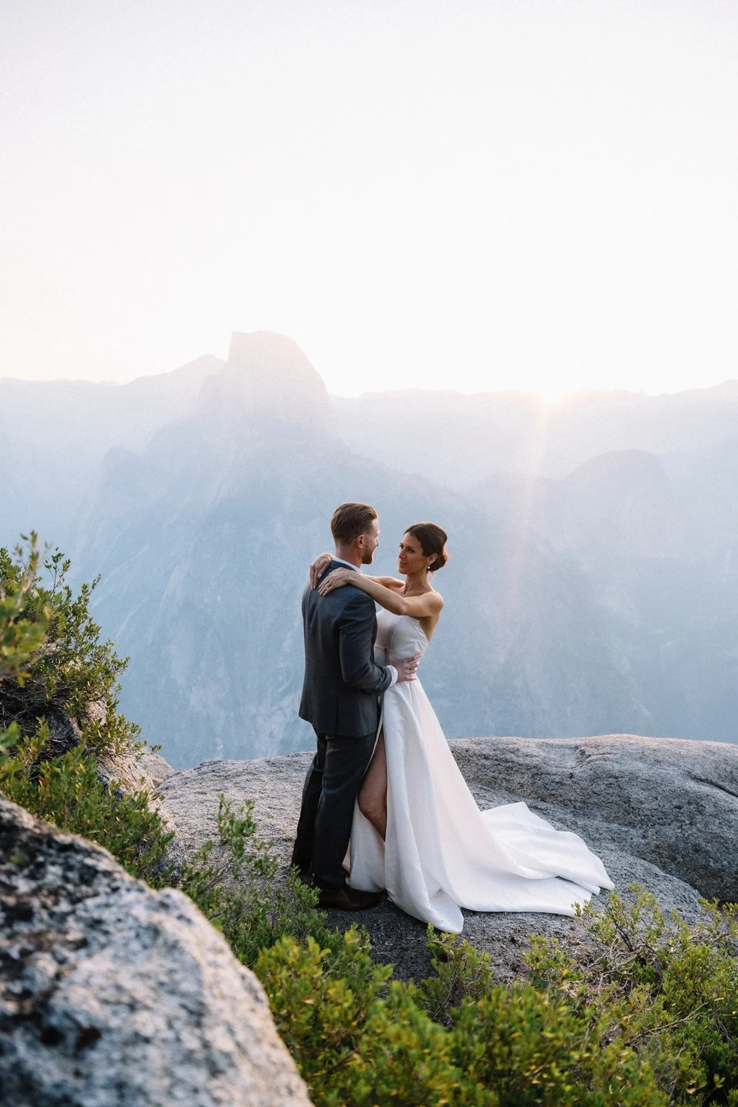 Couple embracing on Taft Point ledge overlooking Yosemite Valley — AJ Photography