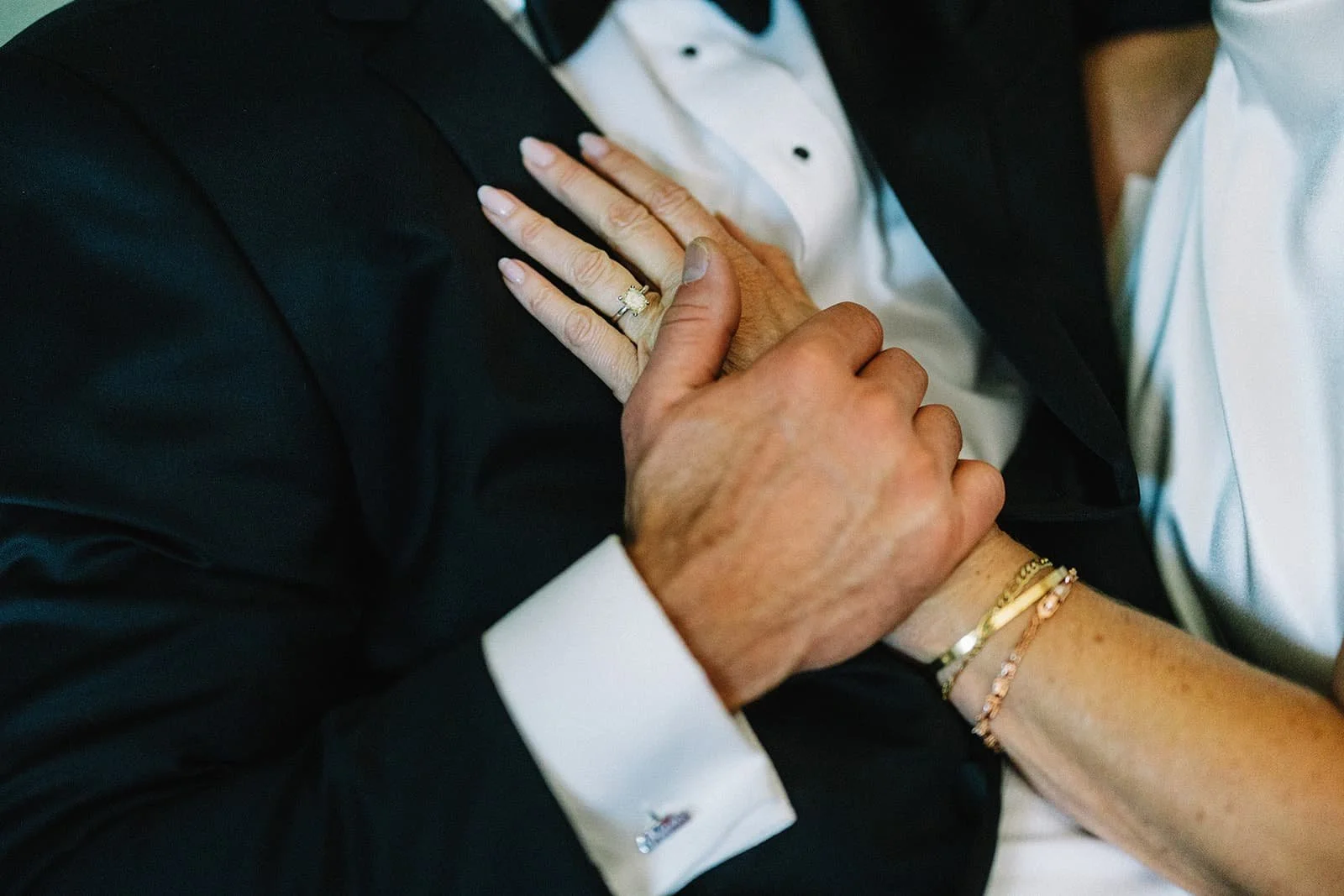 close up on bride and groom hands.jpg