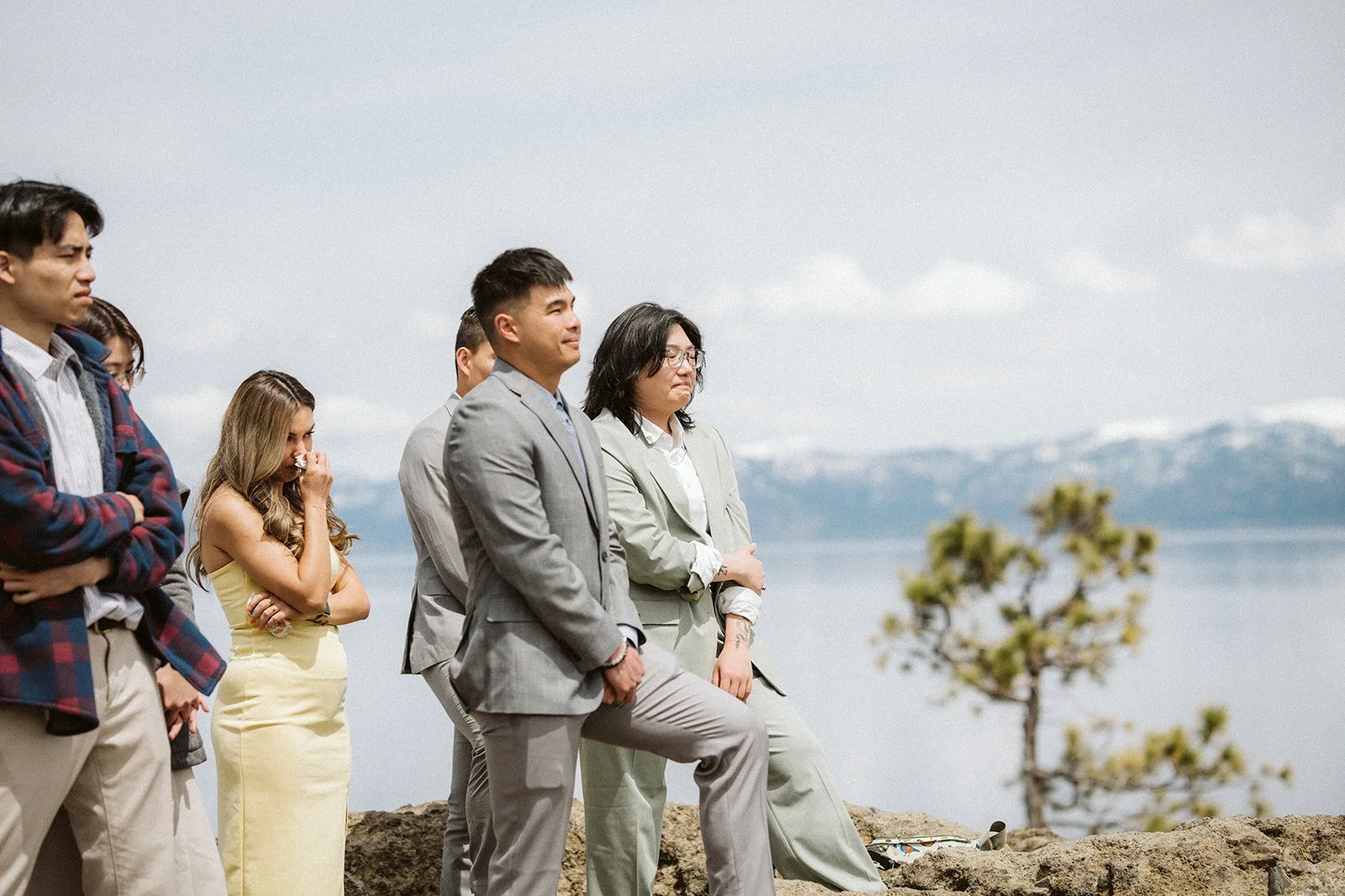 Intimate elopement gathering at Lake Tahoe shoreline on overcast day — AJ Photography