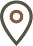 A black map marker icon with a brown circle in the center