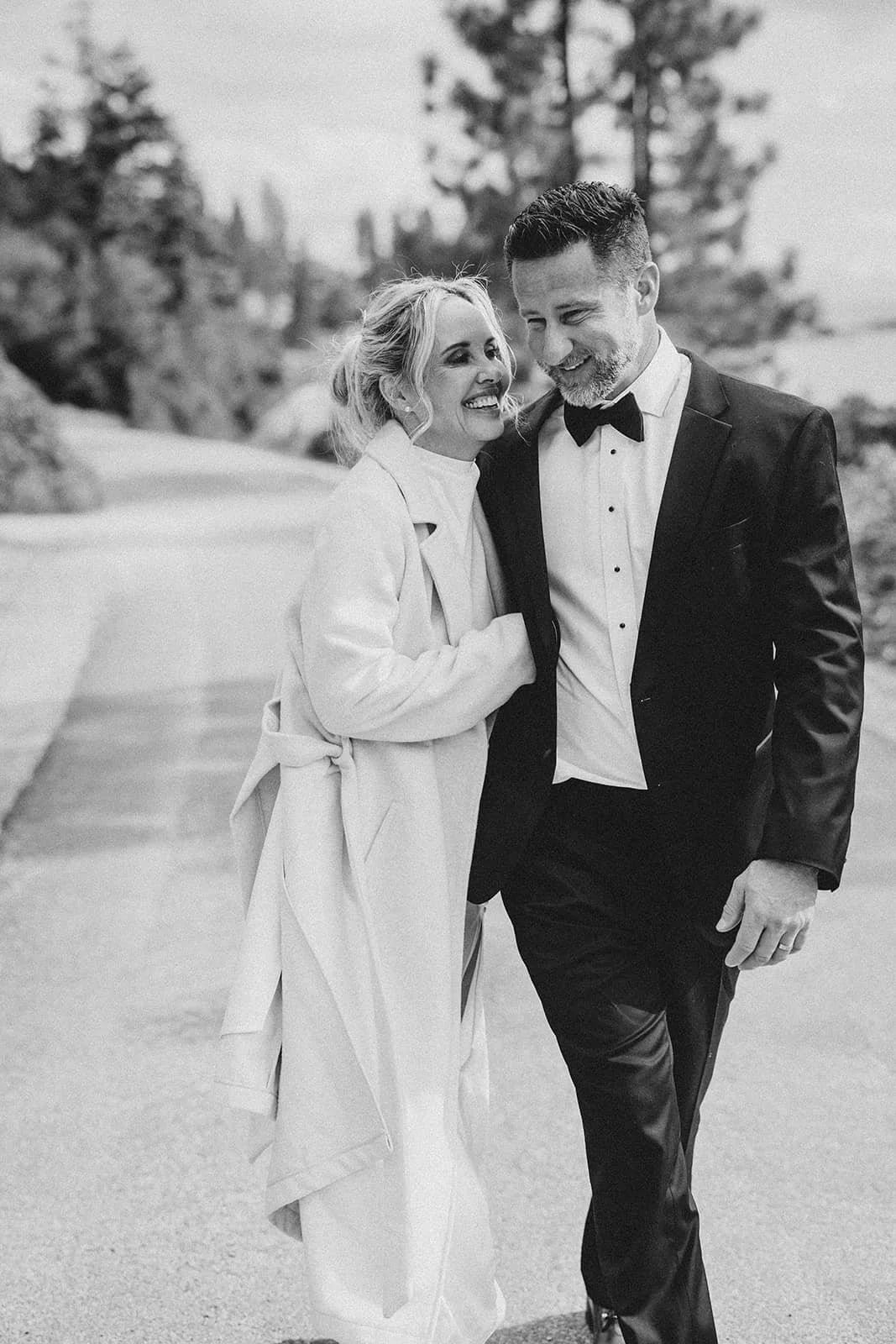 Bride and groom walking together and laughing.jpg