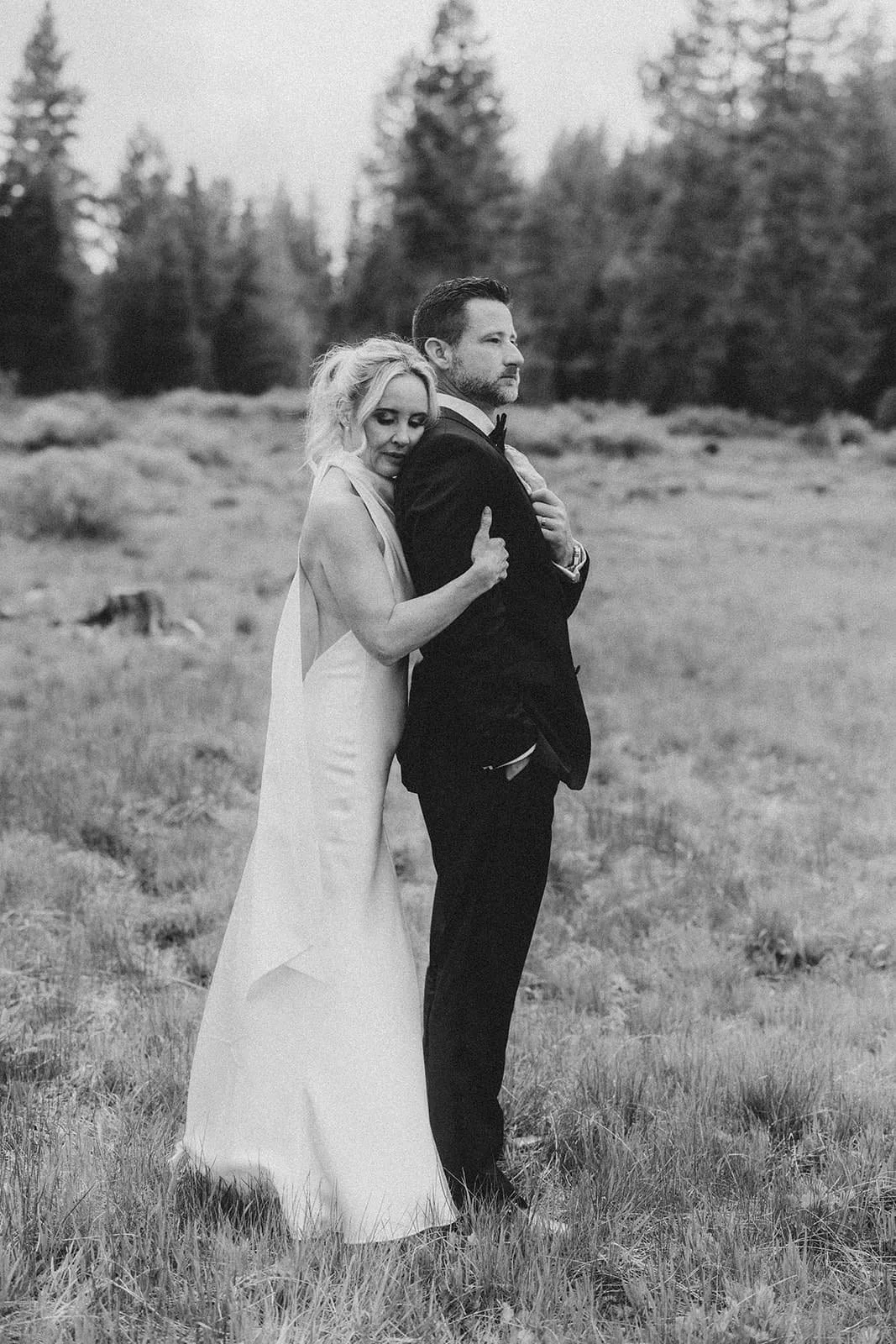 Bride and groom embracing in a meadow in lake tahoe.jpg