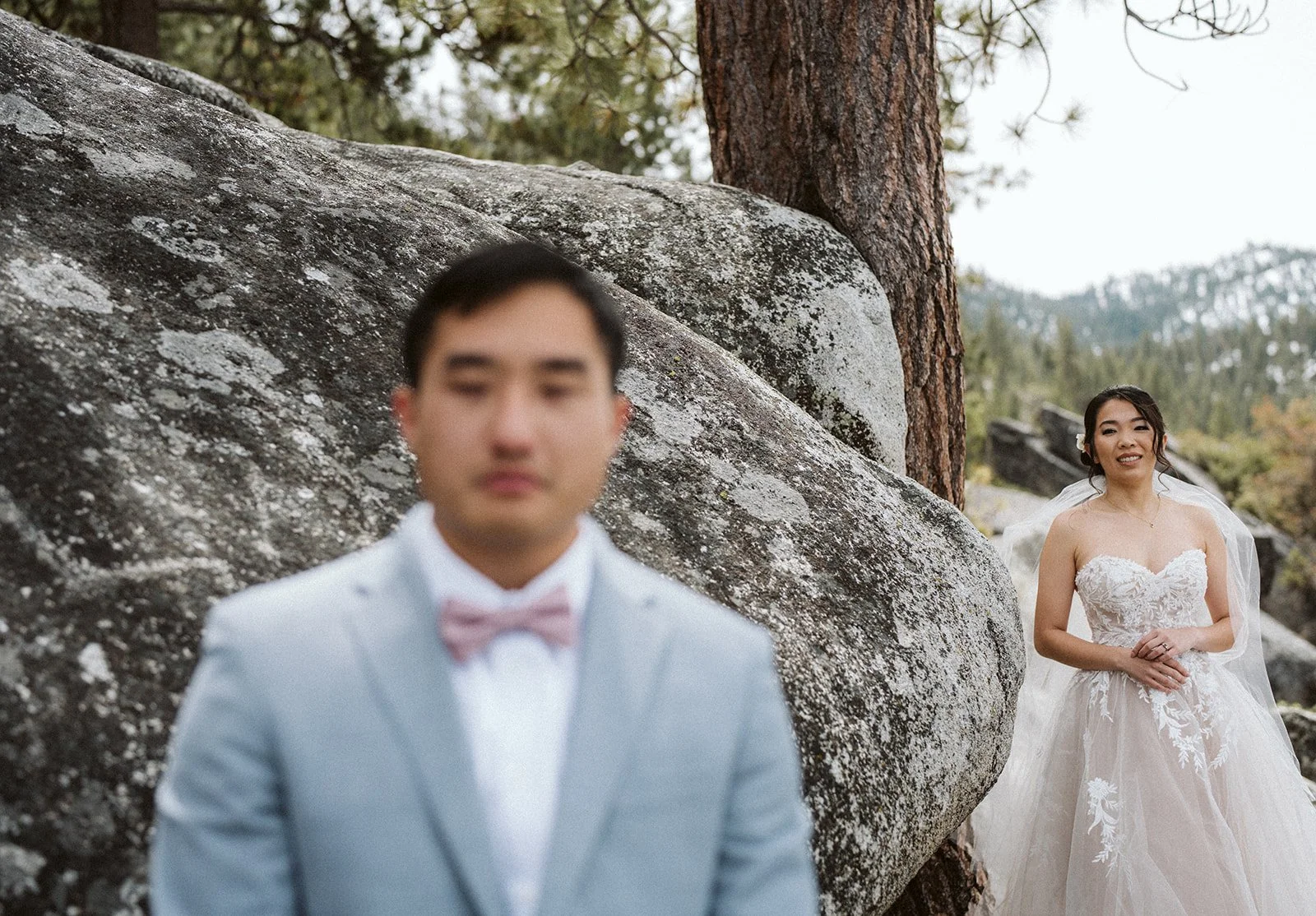 Bride and groom smiling together on Lake Tahoe rocks during elopement — AJ Photography