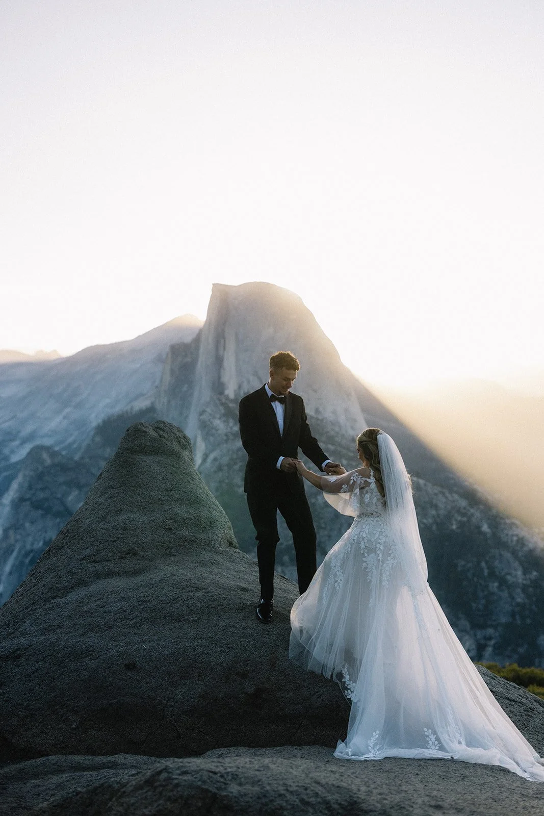 Couple standing in front of a granite rock formation in Yosemite