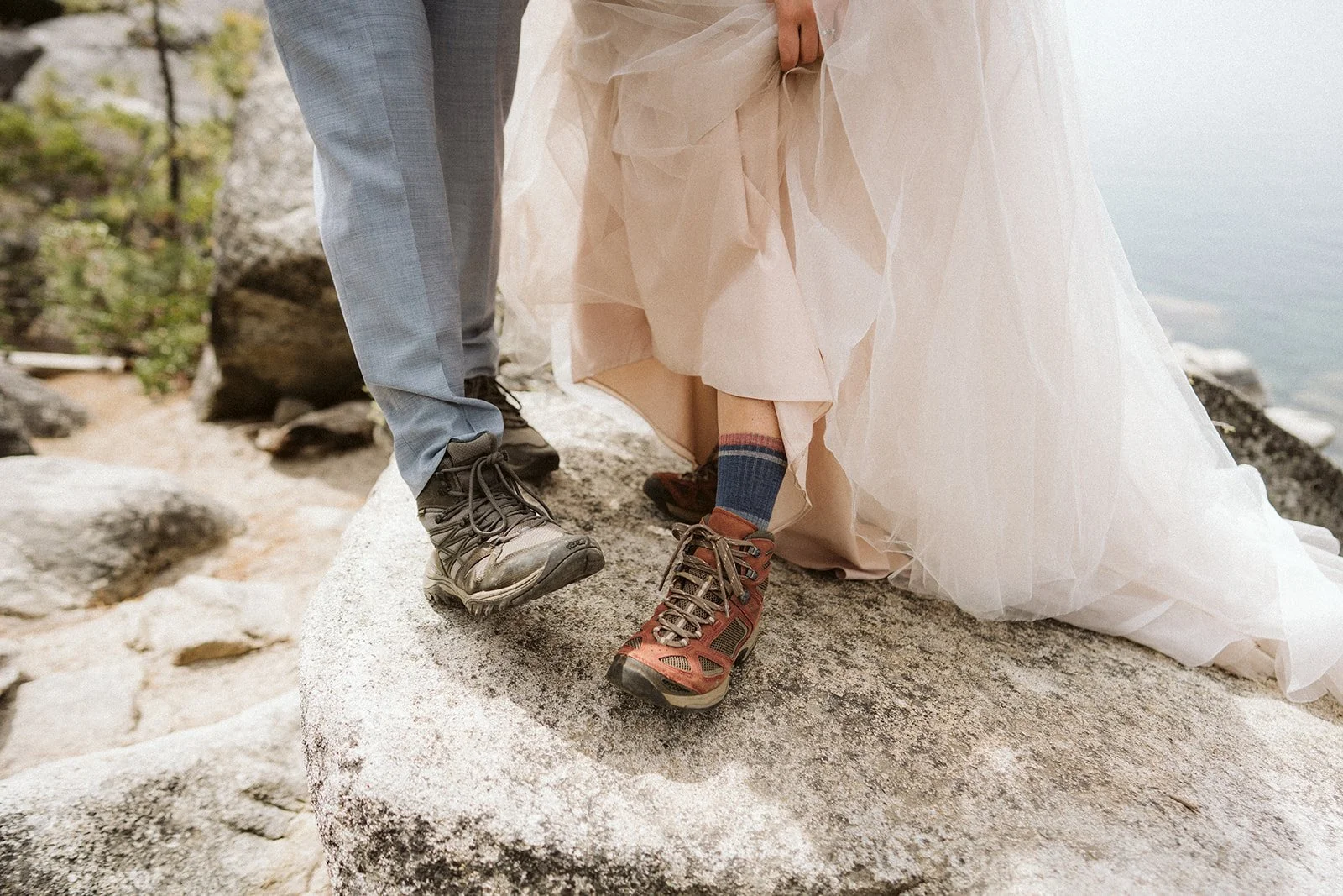 Detail shot of bride and groom standing on lakeside rocks, Lake Tahoe elopement — AJ Photography