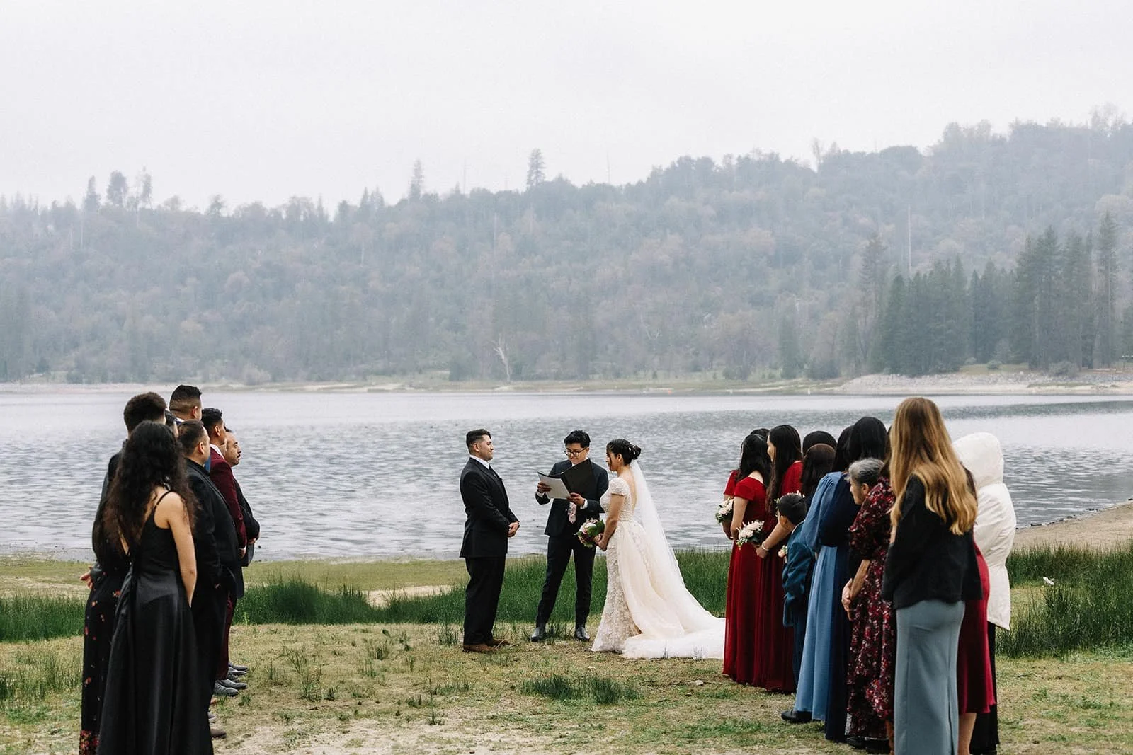 Elopement ceremony at Bass Lake with guests gathered on the shore