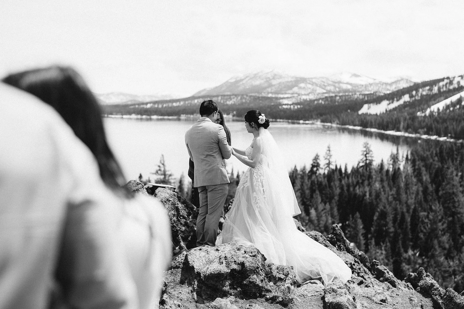 Black and white elopement ceremony on Eagle Rock, Lake Tahoe, with horse in foreground — AJ Photography