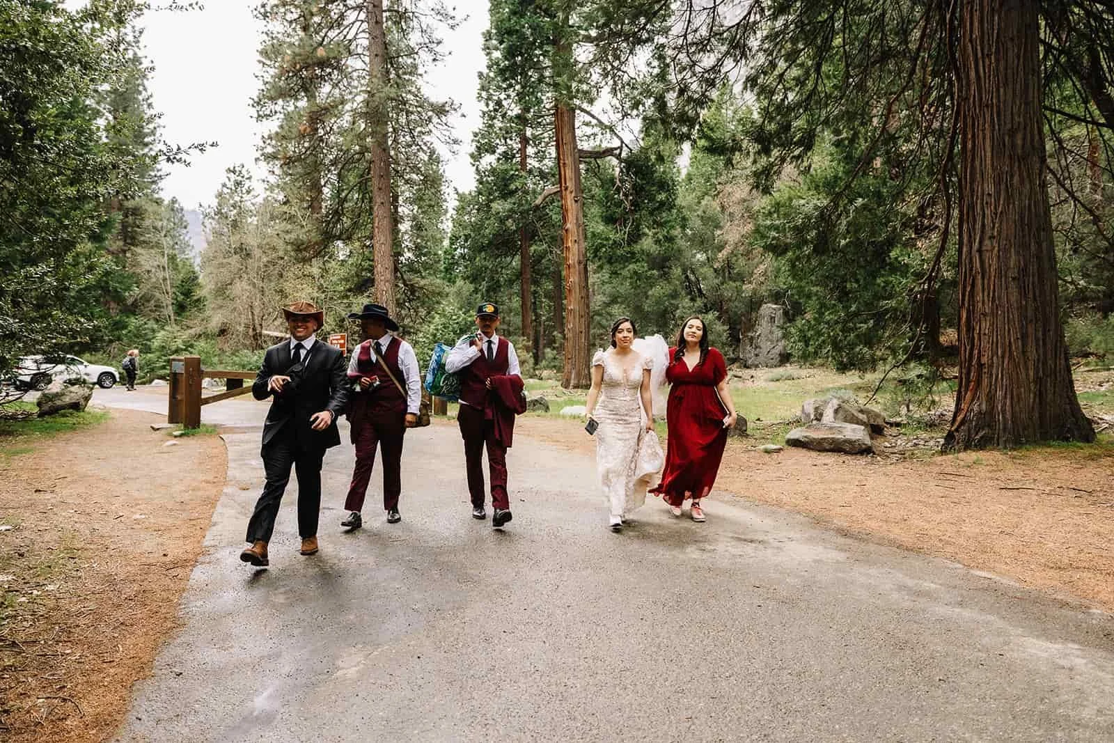 Wedding party walking a forest road near Yosemite Falls