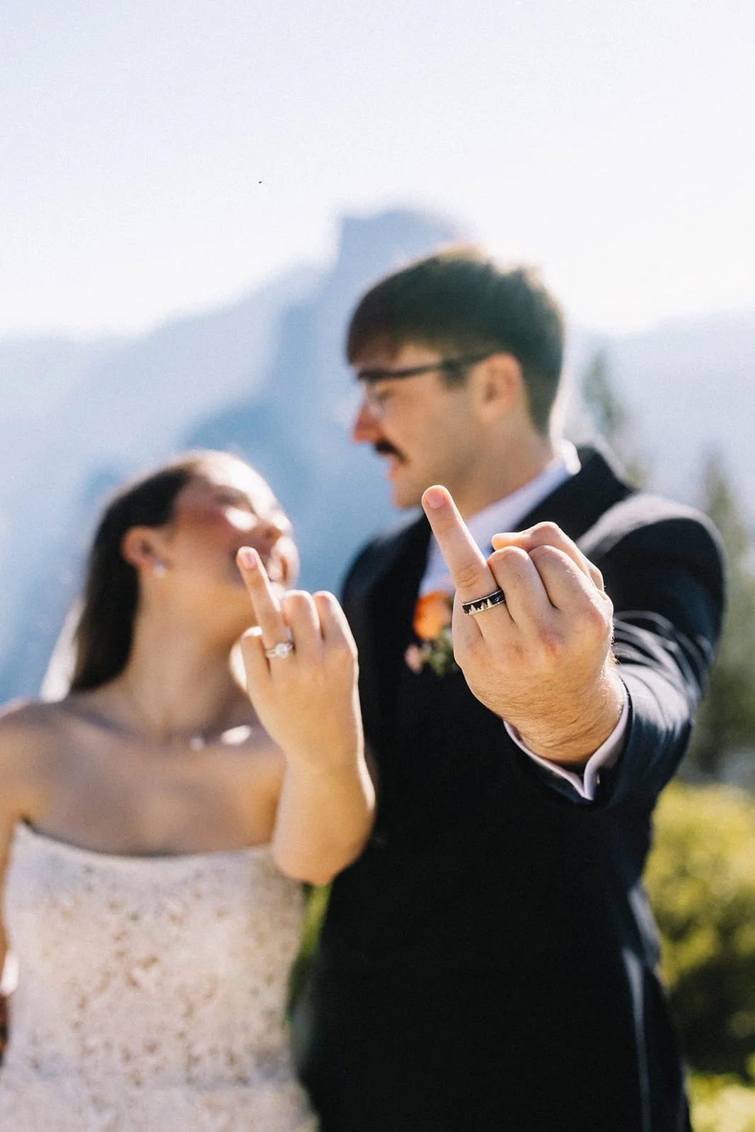 A newlywed couple showing off their wedding rings in Yosemite