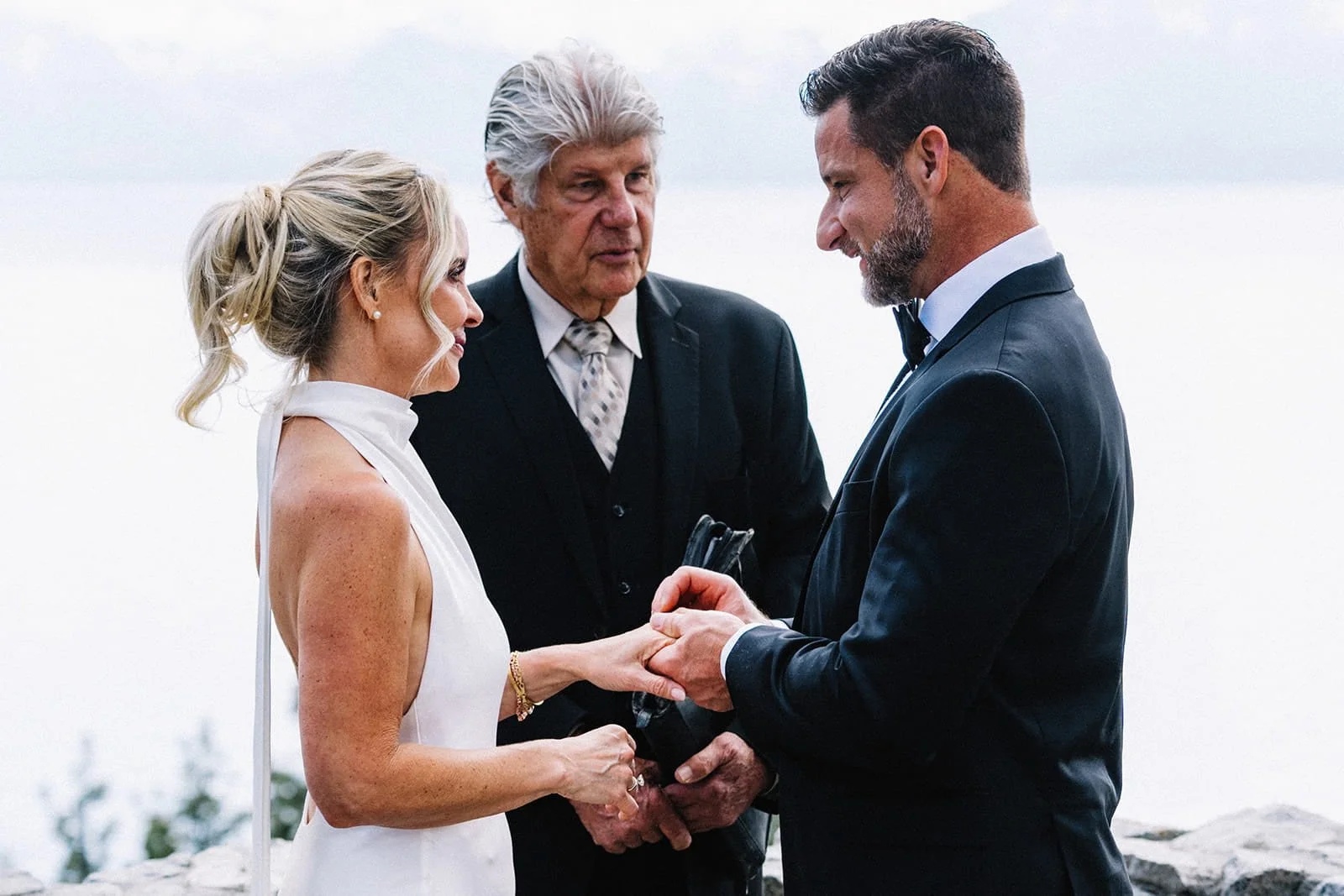 Officiant Thomas Honesco leading the ceremony as the couple holds hands.jpg
