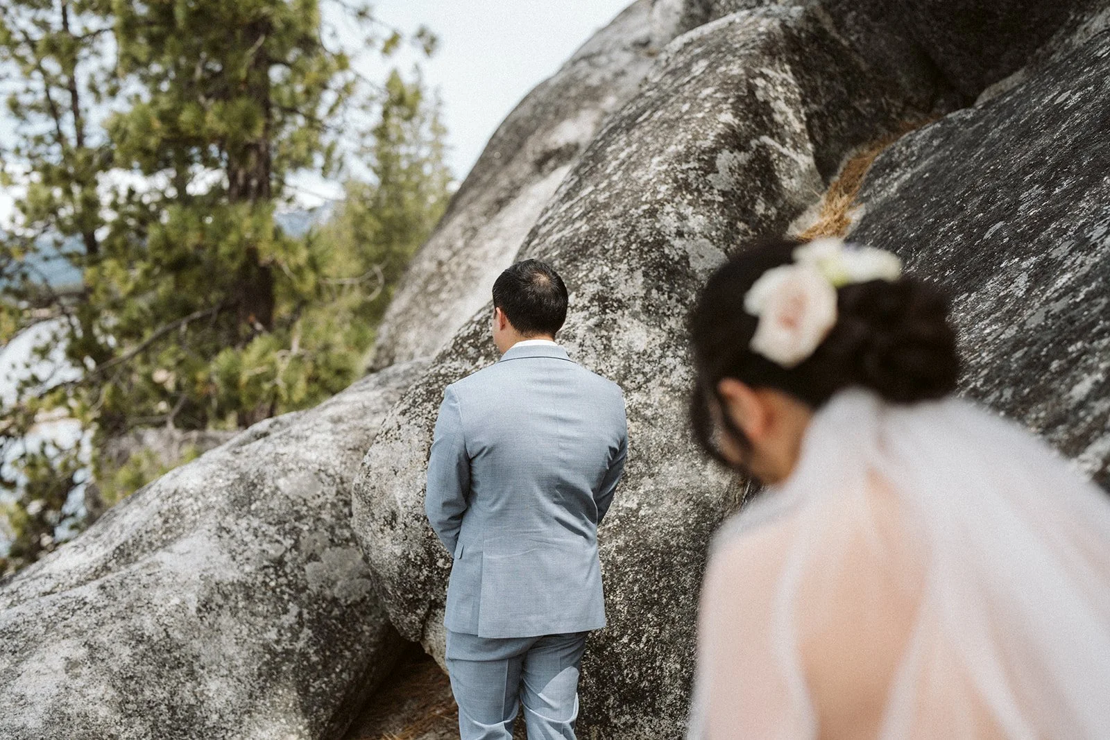 Couple during first look moment at Lake Tahoe granite rocks, elopement portraits — AJ Photography