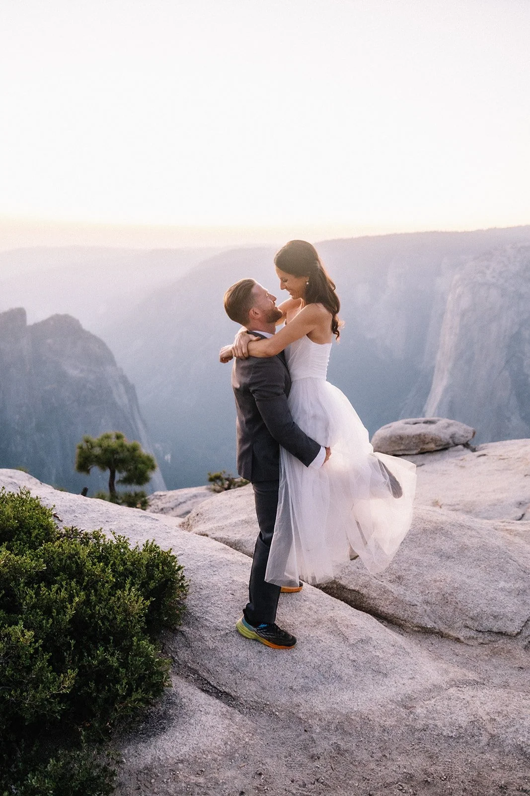 Bride and groom on Taft Point rocky ledge, Yosemite elopement — AJ Photography