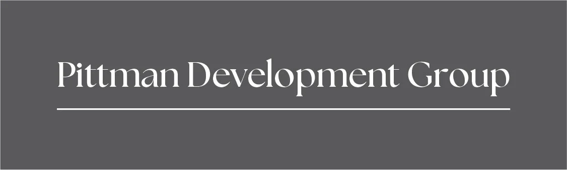Logo of Pittman Development Group on a gray background.